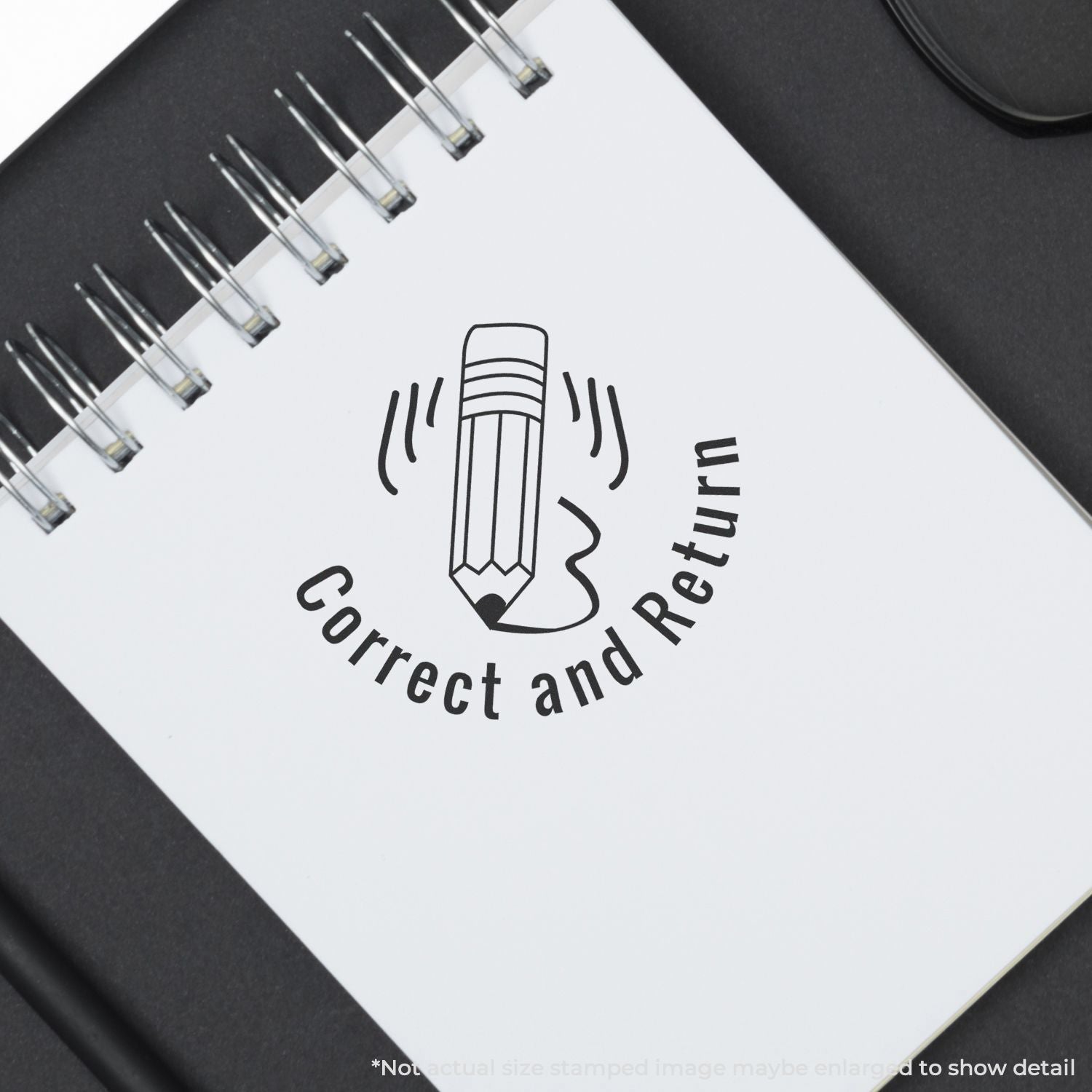 Self Inking Round Correct and Return Stamp used on a notebook, showing a pencil graphic with the text Correct and Return below it.