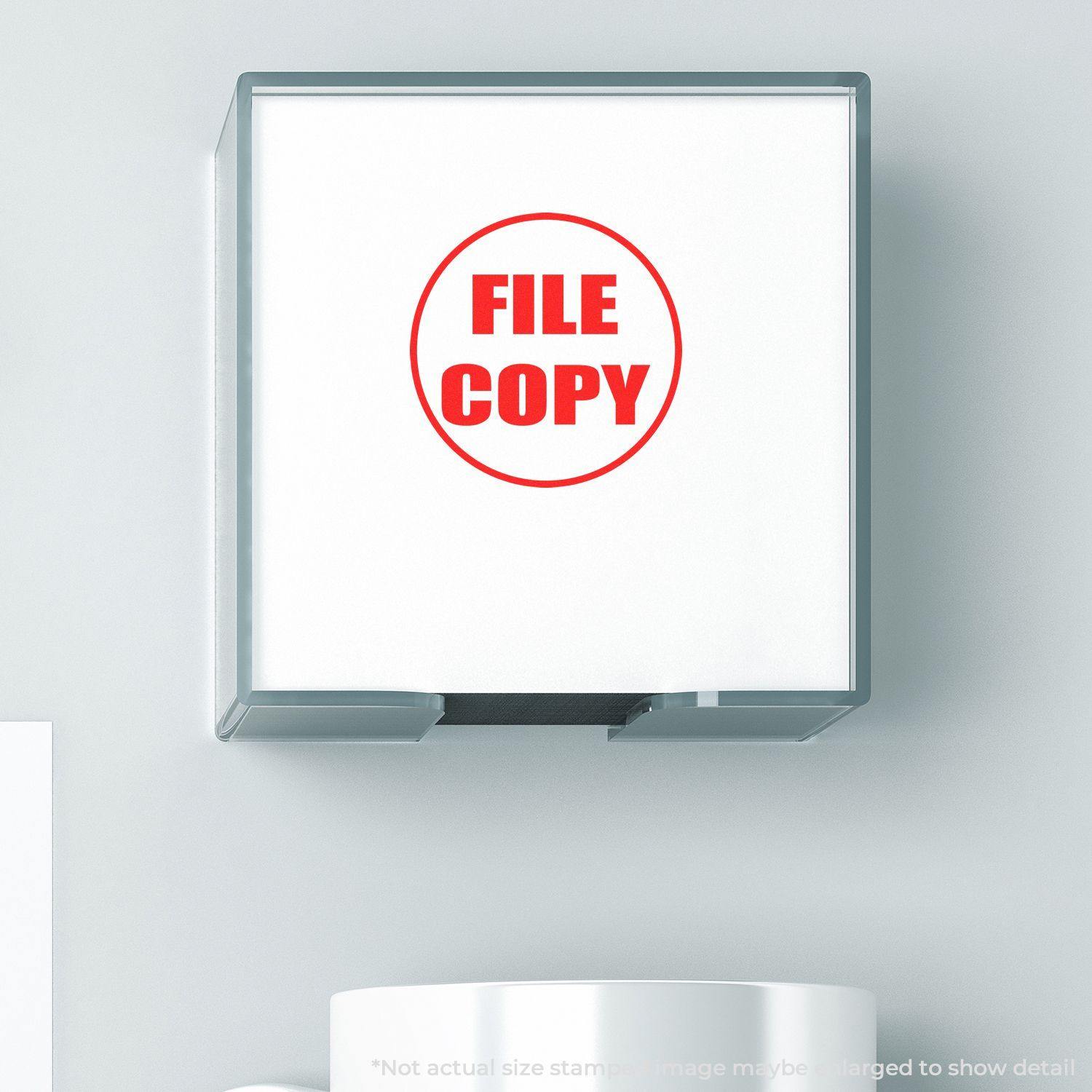 Round File Copy rubber stamp with red text on a white background, mounted on a clear holder, placed on a light-colored surface.