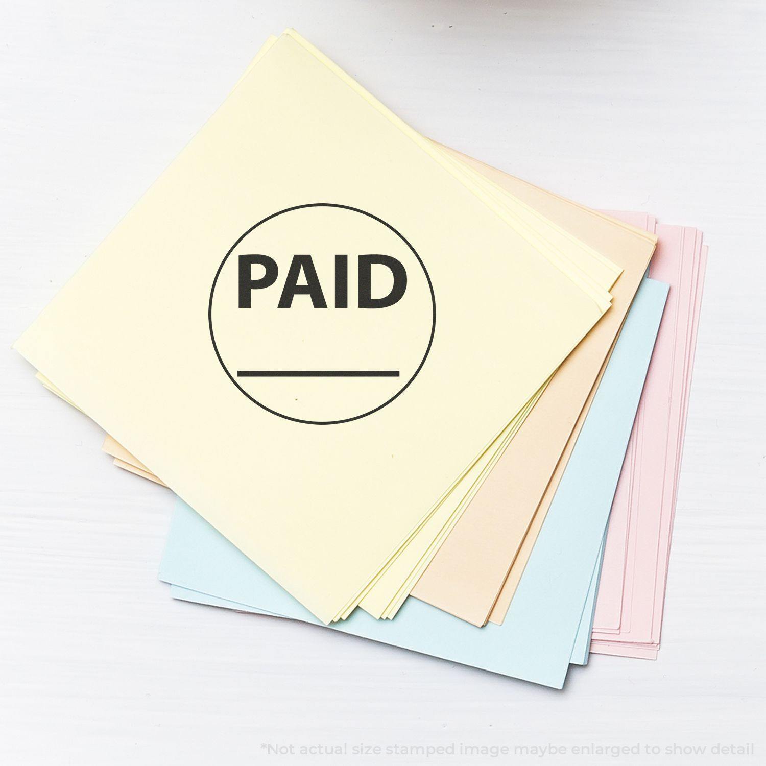 A stack of pastel-colored papers with a Round Paid with Line Rubber Stamp mark on the top sheet.