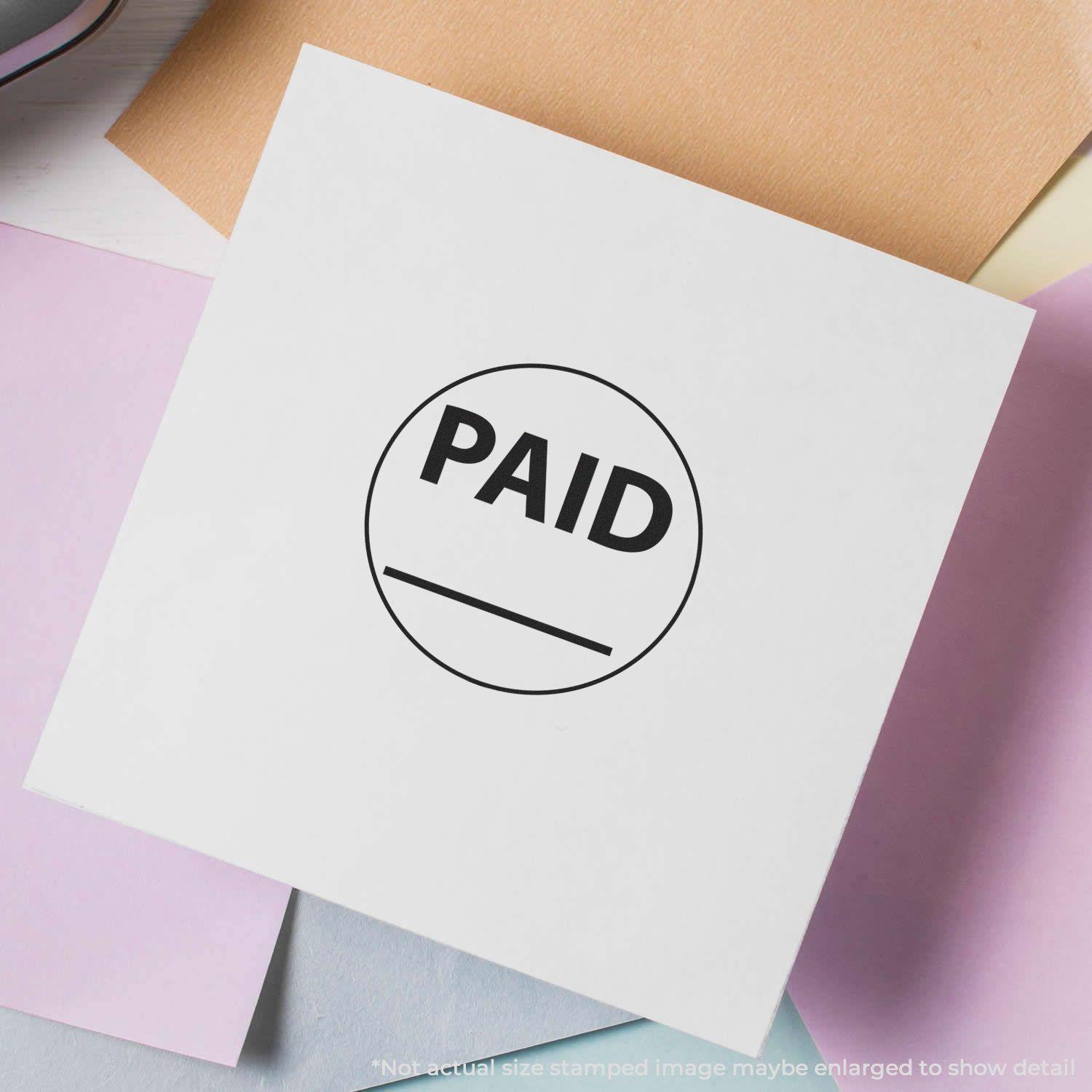 Round Paid with Line Rubber Stamp on a white paper, surrounded by pastel-colored papers.