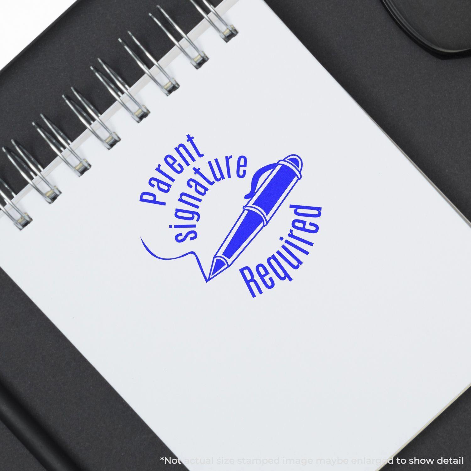 Round Parent Signature Required Rubber Stamp in blue ink on a spiral notebook, depicting a pen and text Parent Signature Required .