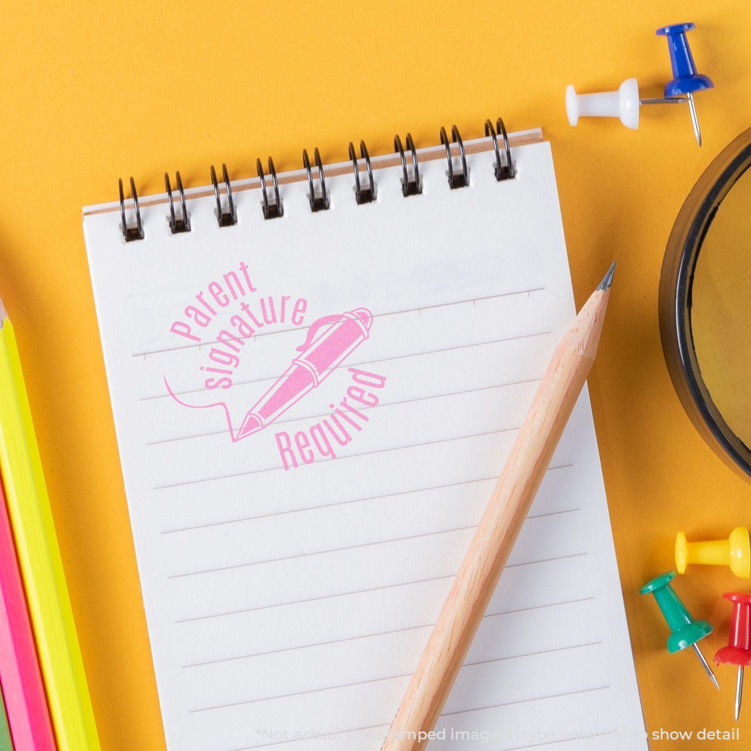 Round Parent Signature Required rubber stamp impression on a notepad with a pencil, colored pens, and push pins on a yellow background.