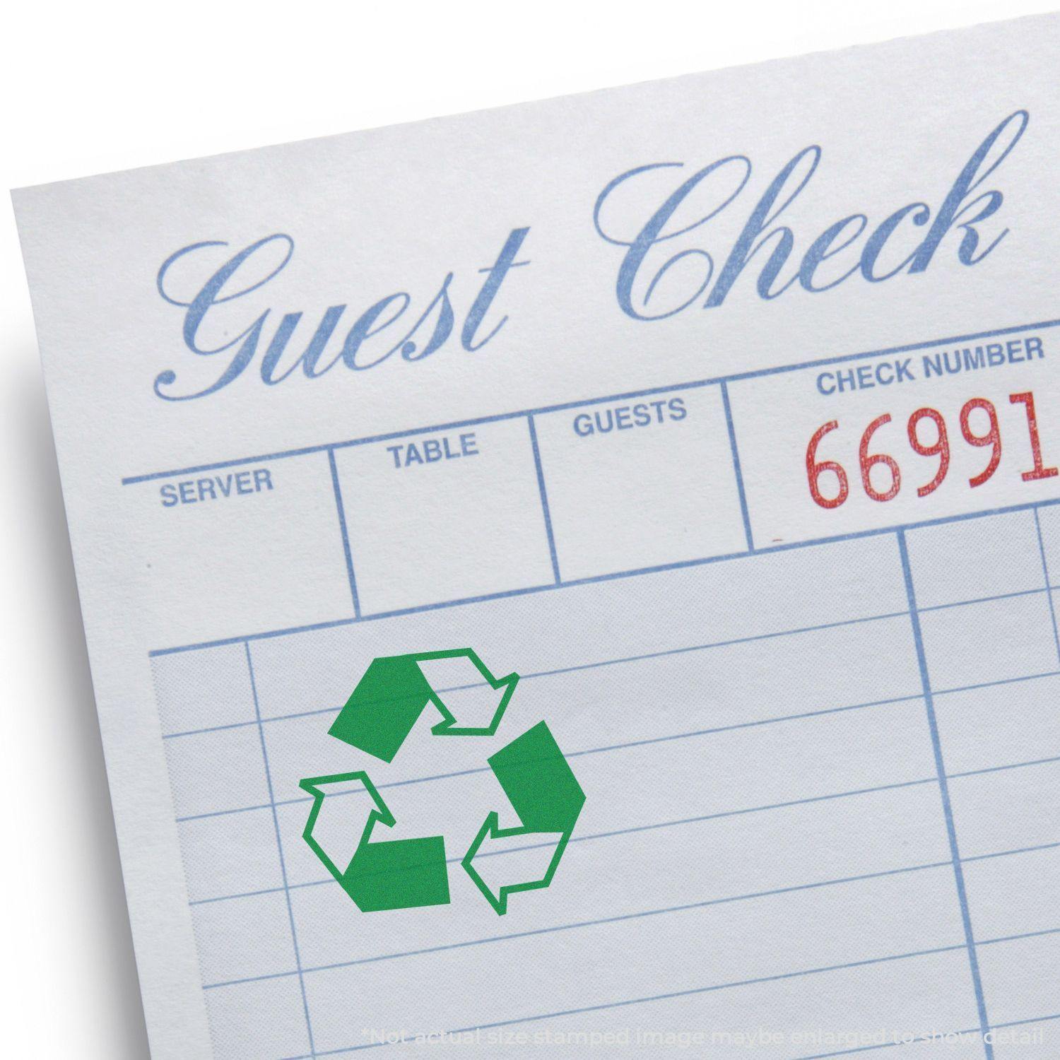 Guest check paper with a green round recycle rubber stamp featuring the recycling symbol in the center.