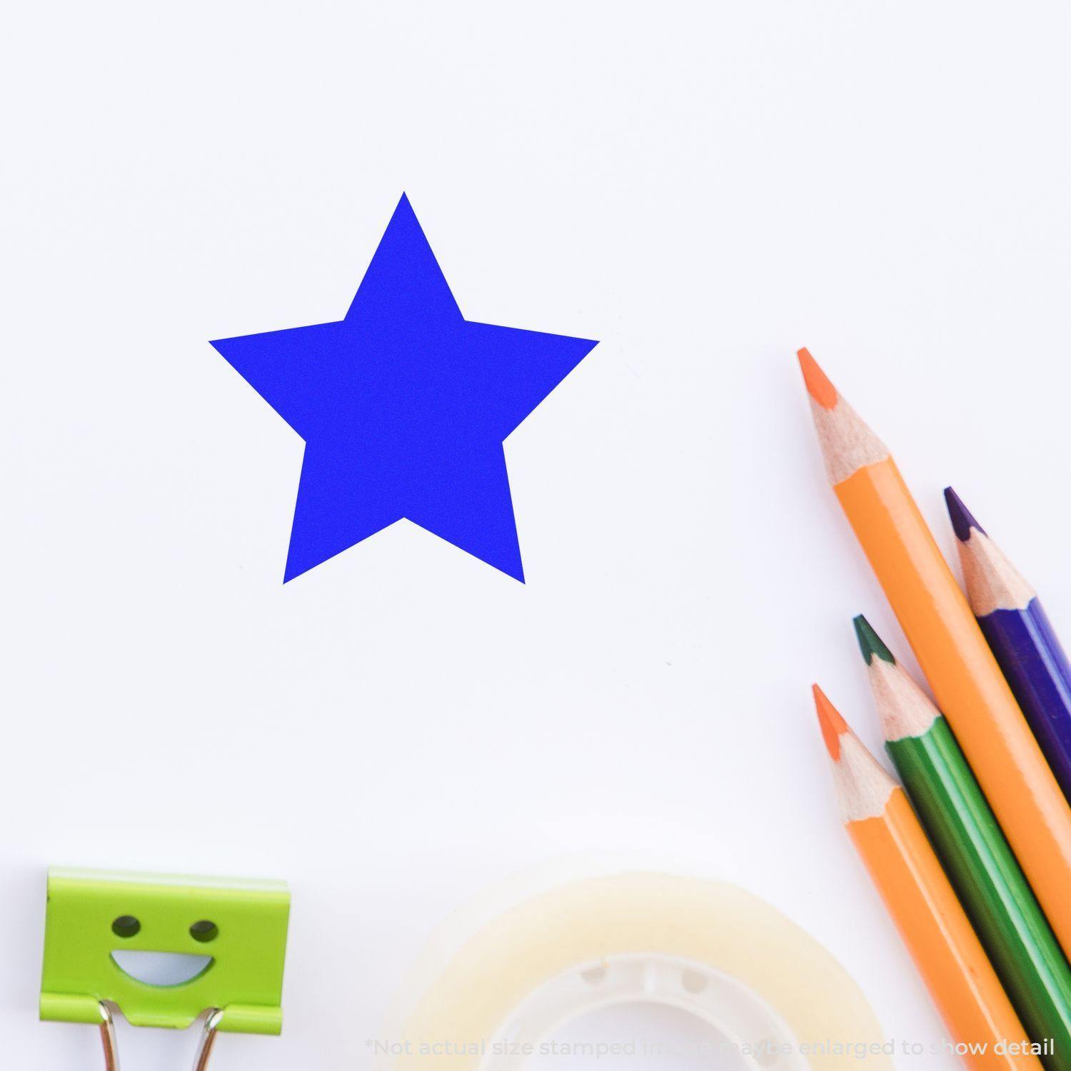 Round Solid Star Rubber Stamp in blue ink on white paper, surrounded by colored pencils, tape, and a smiling binder clip.