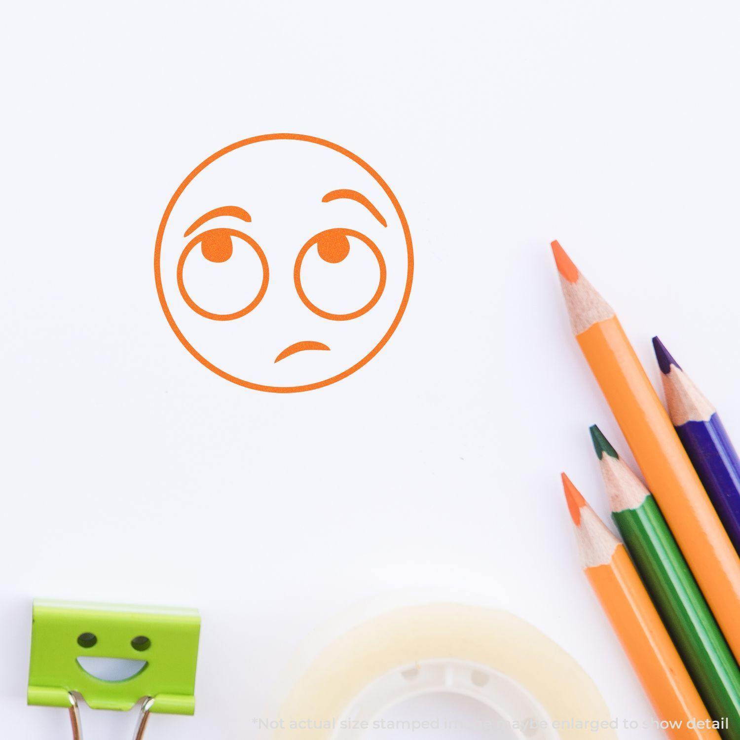 Round Whatever Smiley Rubber Stamp in orange ink on paper, surrounded by colored pencils, a smiley clip, and tape.