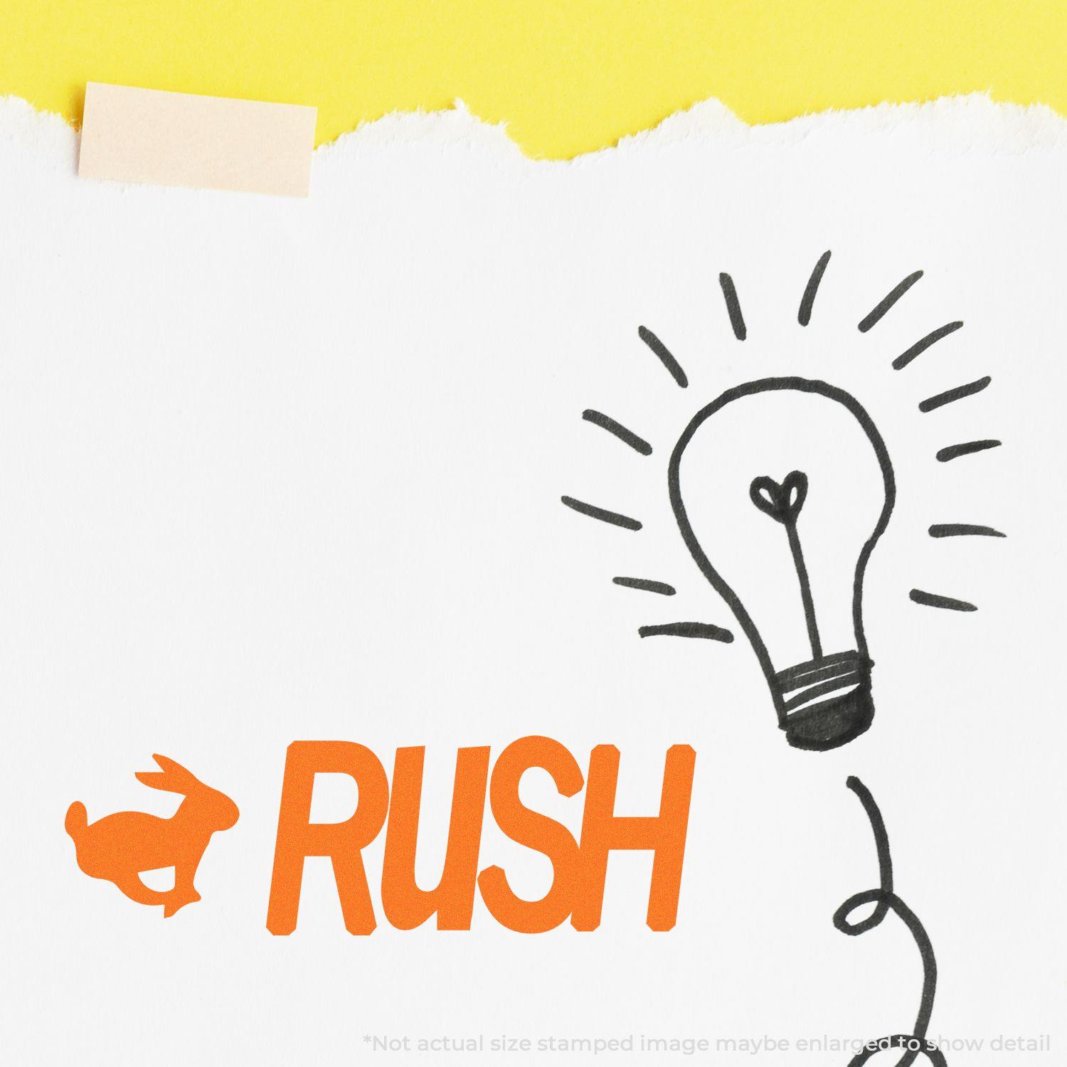 Paper with Slim Pre-Inked Rush with Rabbit Stamp in orange and a hand-drawn light bulb, taped to a yellow background.