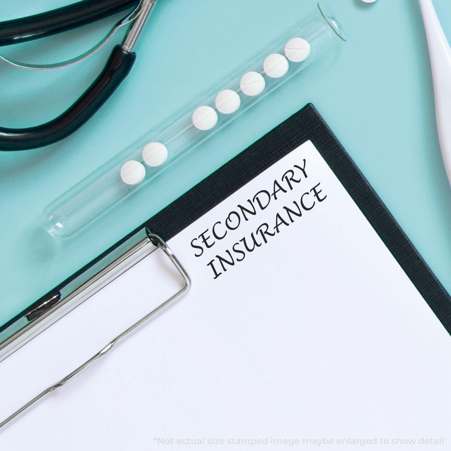 Clipboard with Secondary Insurance rubber stamp, stethoscope, and pills in a test tube on a light blue background.