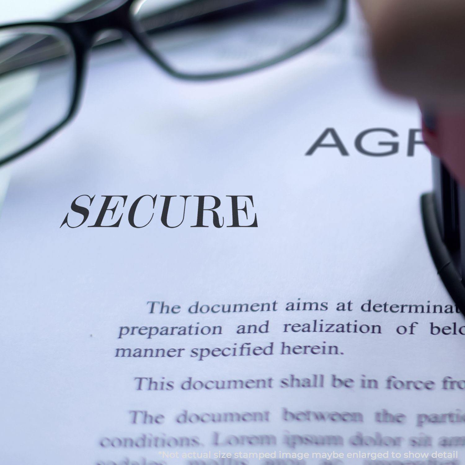 Large Self Inking Secure Stamp being used on a document with glasses in the background. The word SECURE is stamped on the paper.