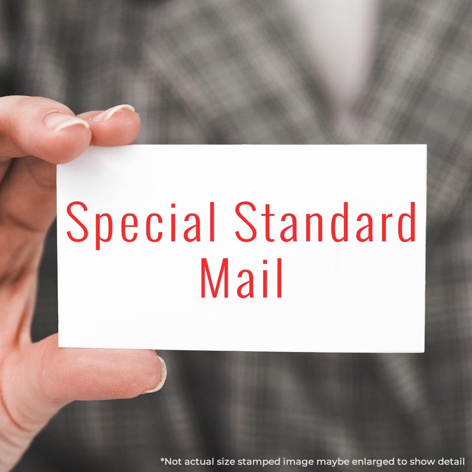 Person holding a card stamped with Special Standard Mail using a Slim Pre-Inked Special Standard Mail Stamp.