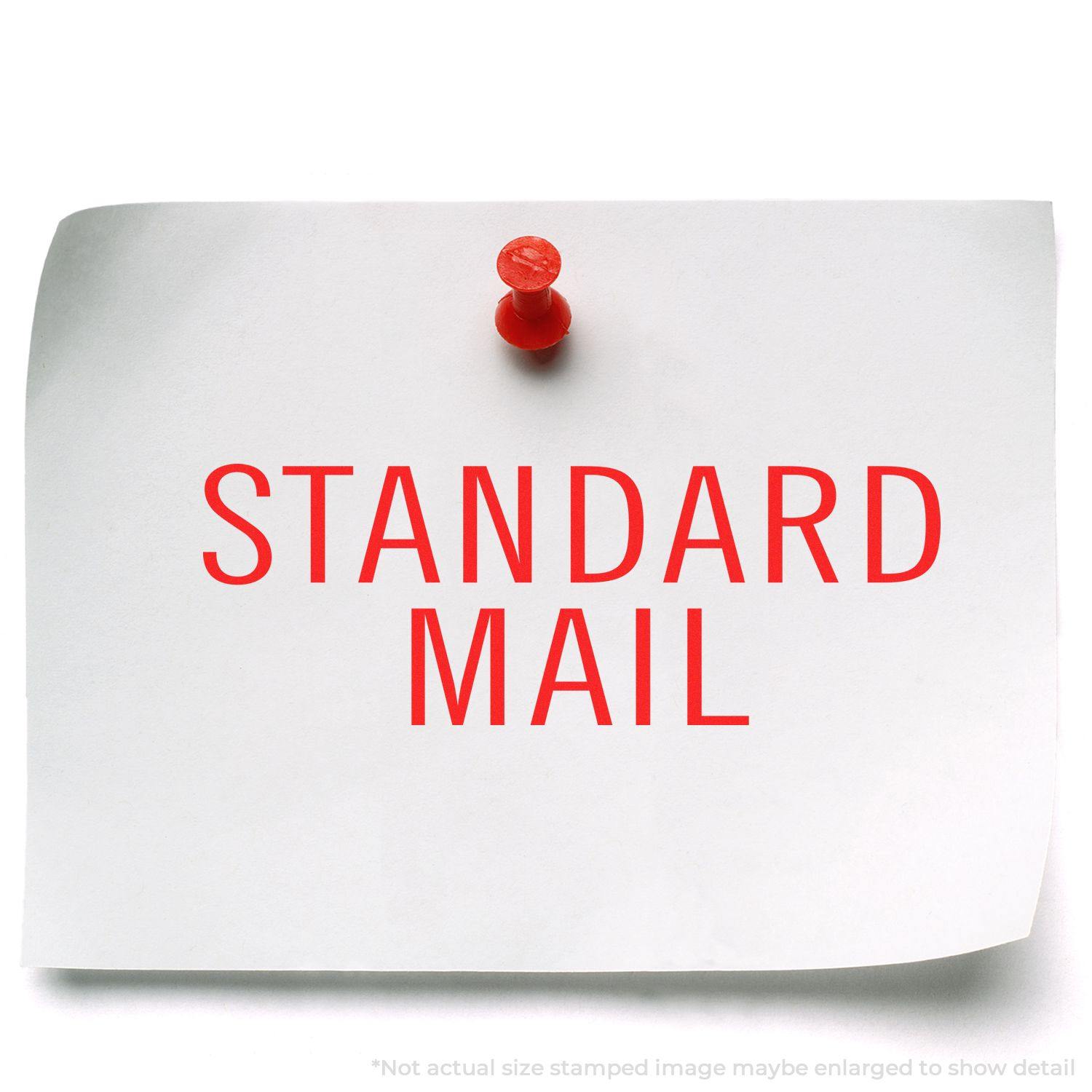 A white paper with STANDARD MAIL in red, pinned to a surface. Stamped using the Large Pre-Inked Standard Mail Stacked Stamp.