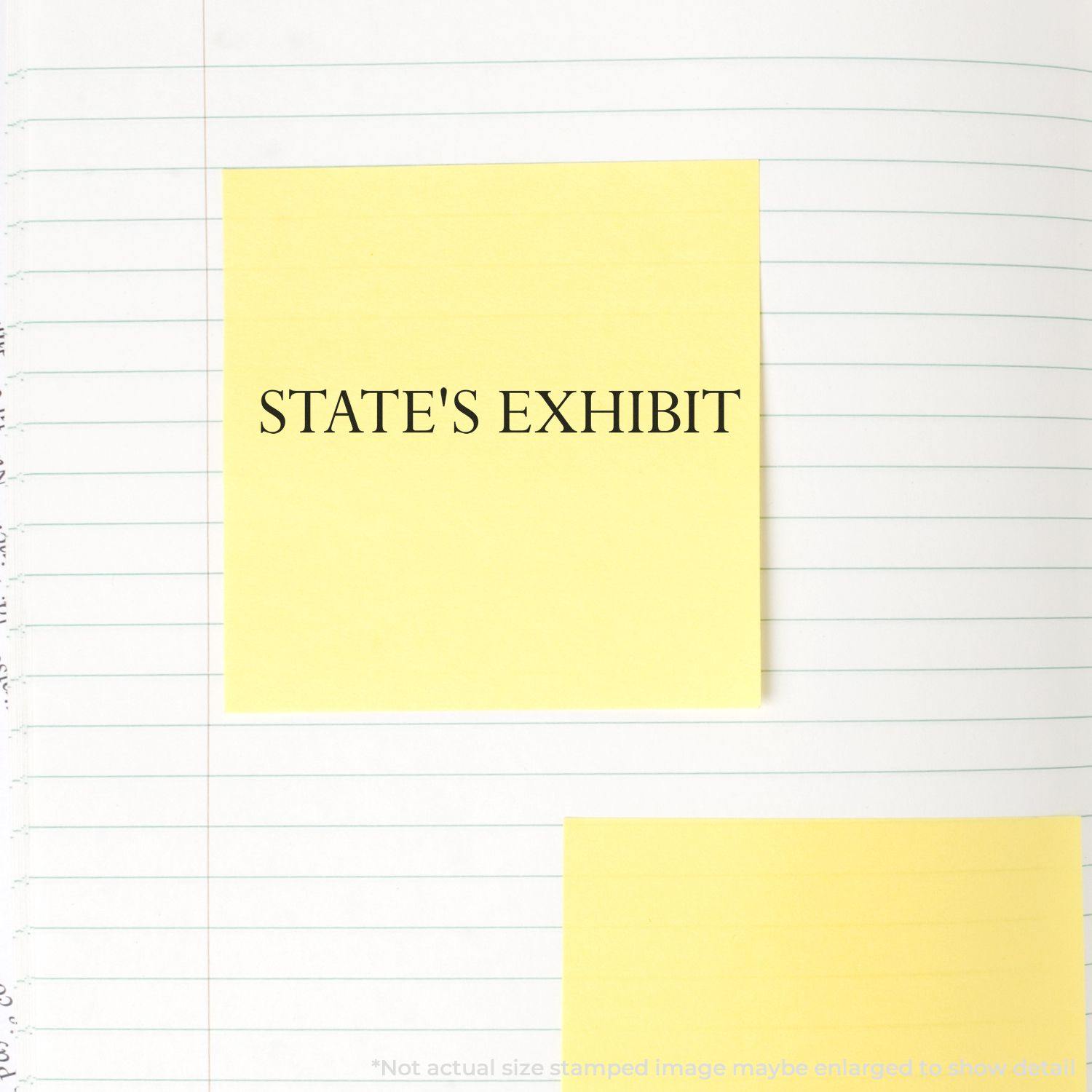 Large Pre-Inked States Exhibit Stamp used on a yellow sticky note placed on a lined notebook page.