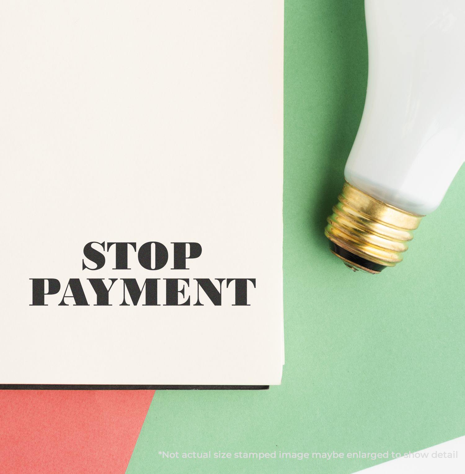 Stop Payment rubber stamp on a white paper with a light bulb on a green and red background.