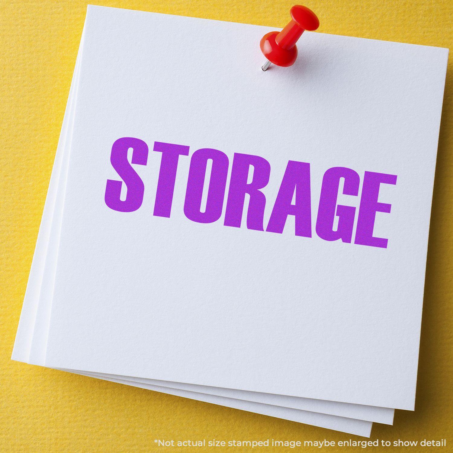 Large Self Inking Storage Stamp used on white paper with a red pushpin, displaying the word STORAGE in bold purple letters.