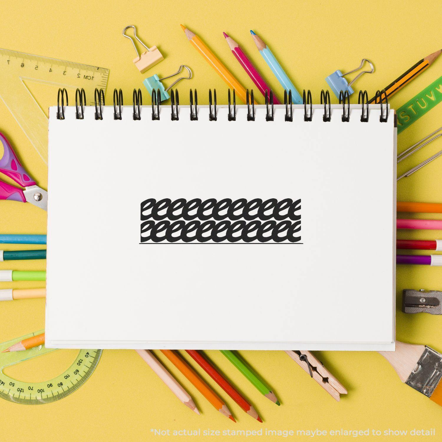 A Self Inking Strikeout Stamp on a white notebook page surrounded by colorful stationery items on a yellow background.