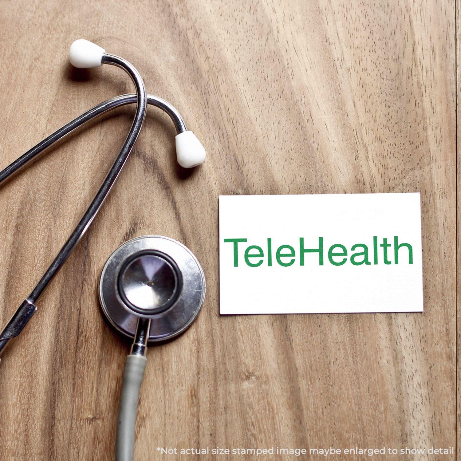 Stethoscope on wooden surface next to a card stamped with TeleHealth using a Slim Pre-Inked Telehealth Stamp.