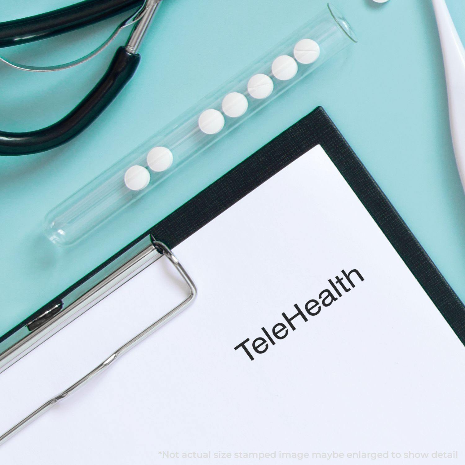 Clipboard with TeleHealth text, stethoscope, and pills on a blue surface. Large Pre-Inked Telehealth Stamp used on the paper.