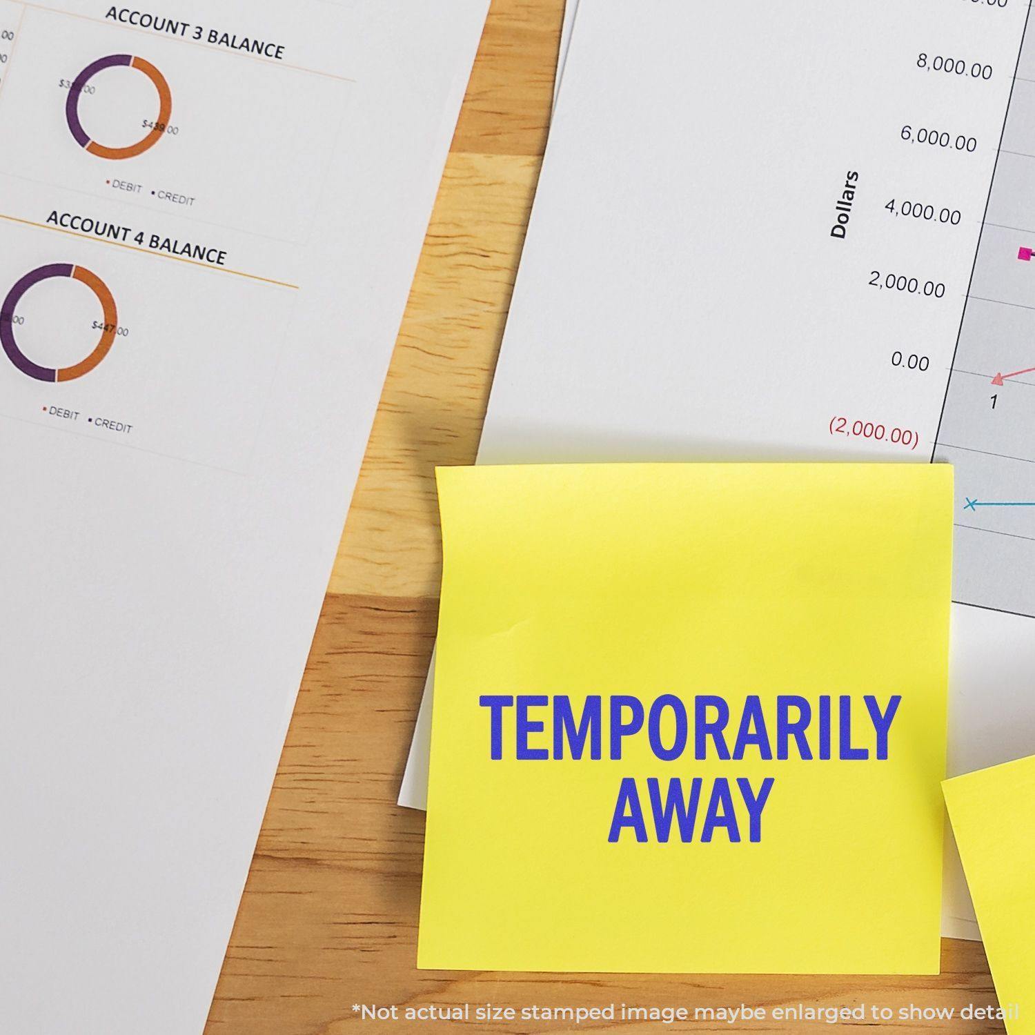 Self Inking Temporarily Away Stamp marking a yellow sticky note on a desk with financial documents and charts in the background.