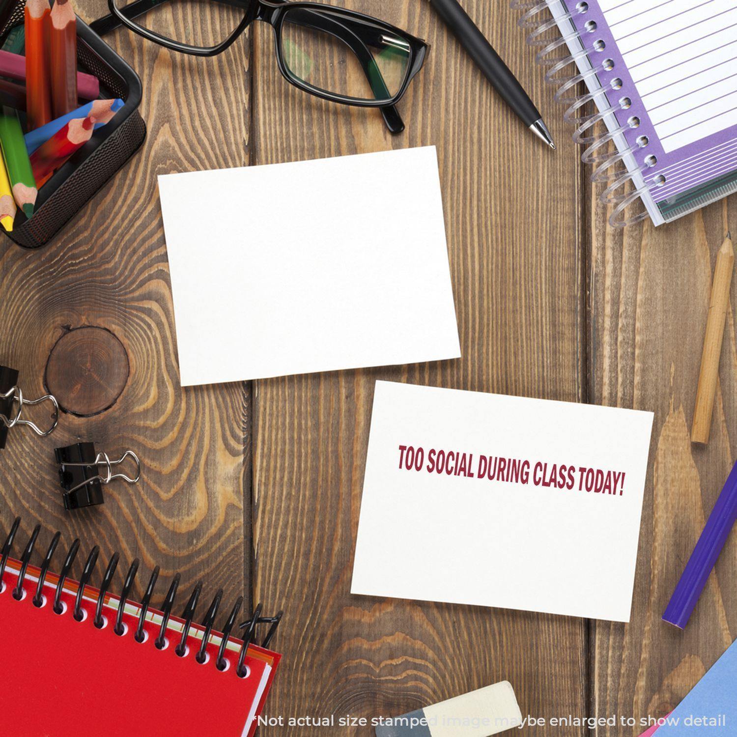 Large Self-Inking Too Social During Class Today Stamp on a wooden desk with stationery, glasses, and notebooks.