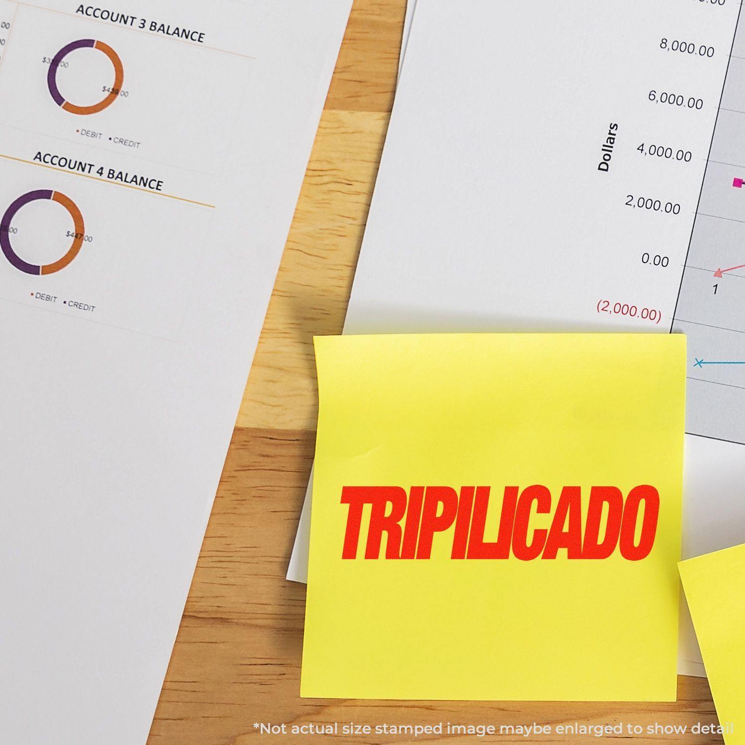 Self Inking Tripilicado Stamp in red ink on a yellow sticky note, placed on a desk with financial documents and charts.