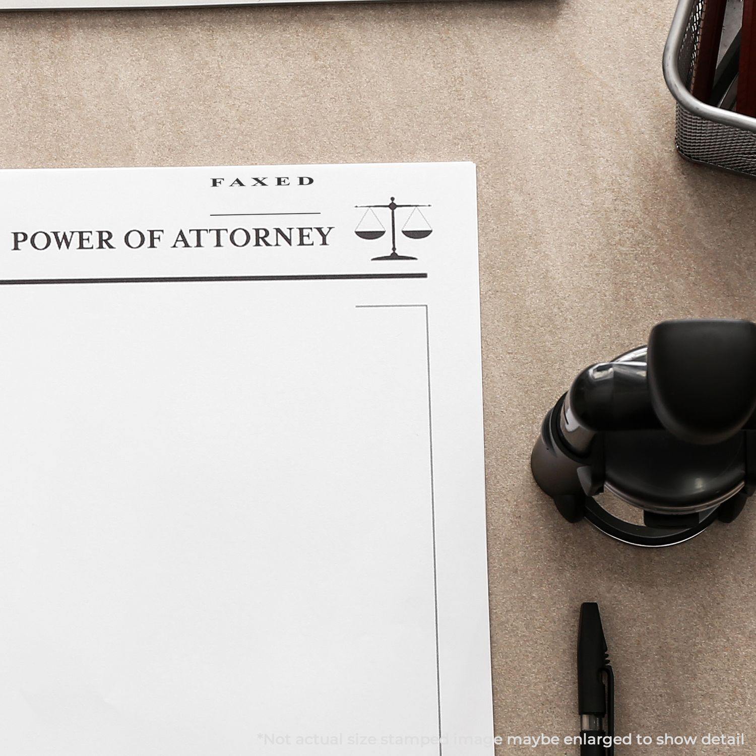 Document stamped with a Two Line Faxed Rubber Stamp on a desk, next to a pen and a stamp holder.