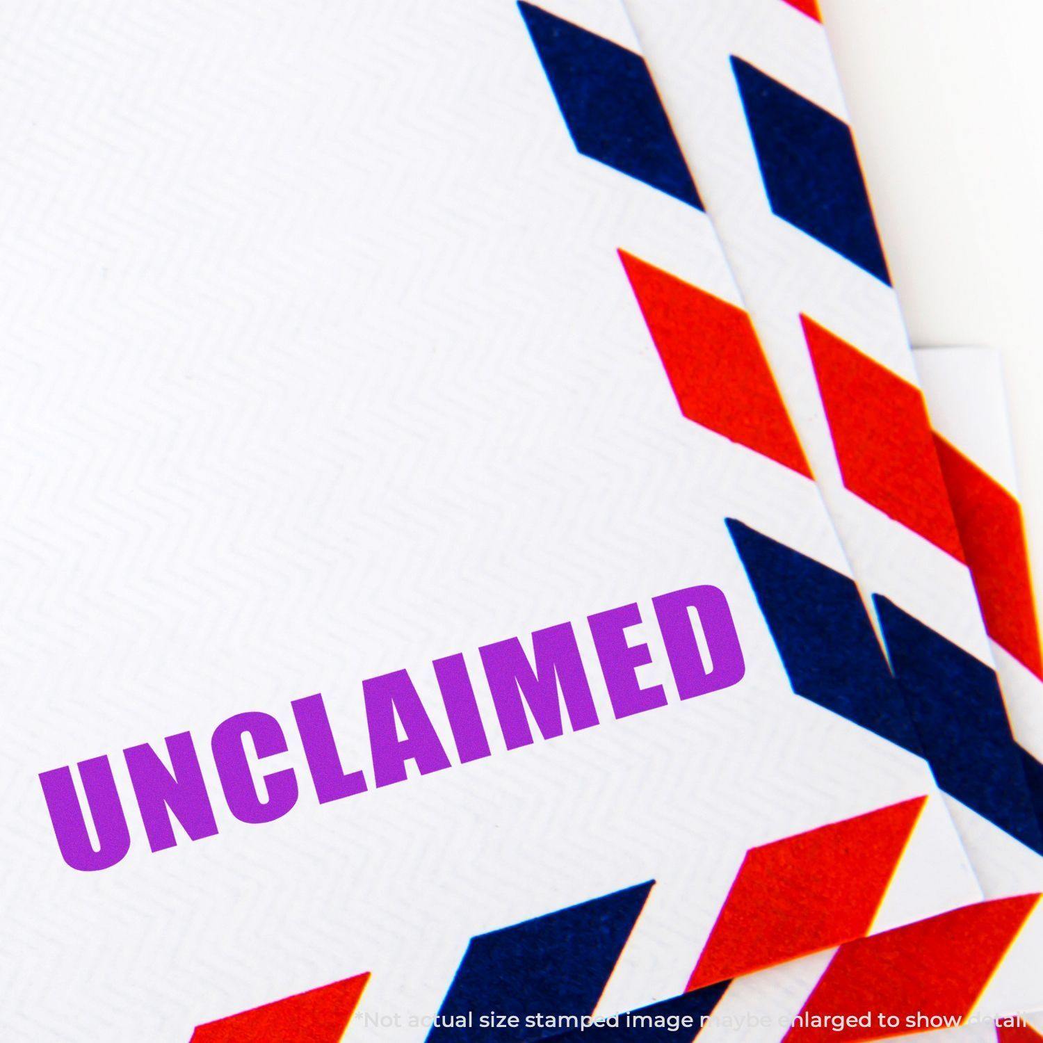 Large Pre-Inked Unclaimed Stamp marking UNCLAIMED in purple on white paper with red and blue border design.