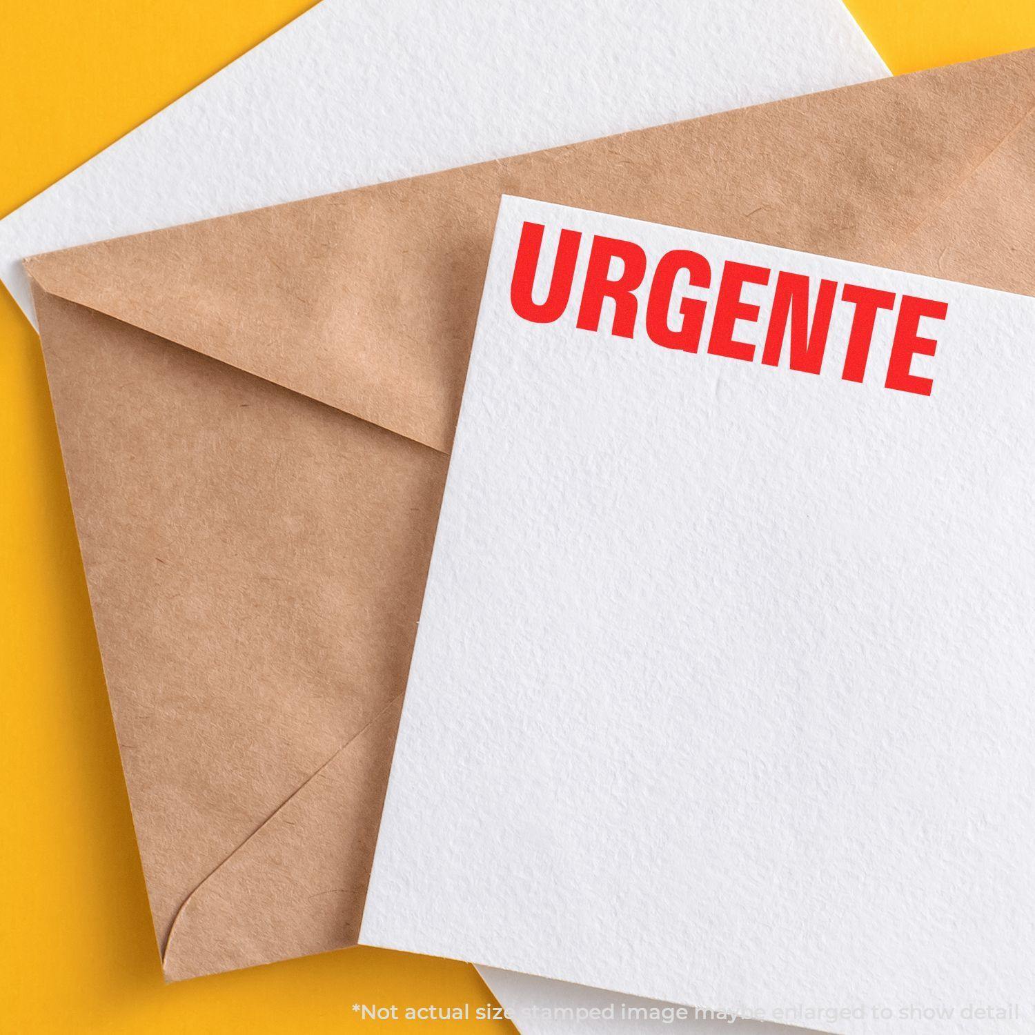 Large Pre-Inked Urgente Stamp used on a white paper, placed on top of a brown envelope against a yellow background.