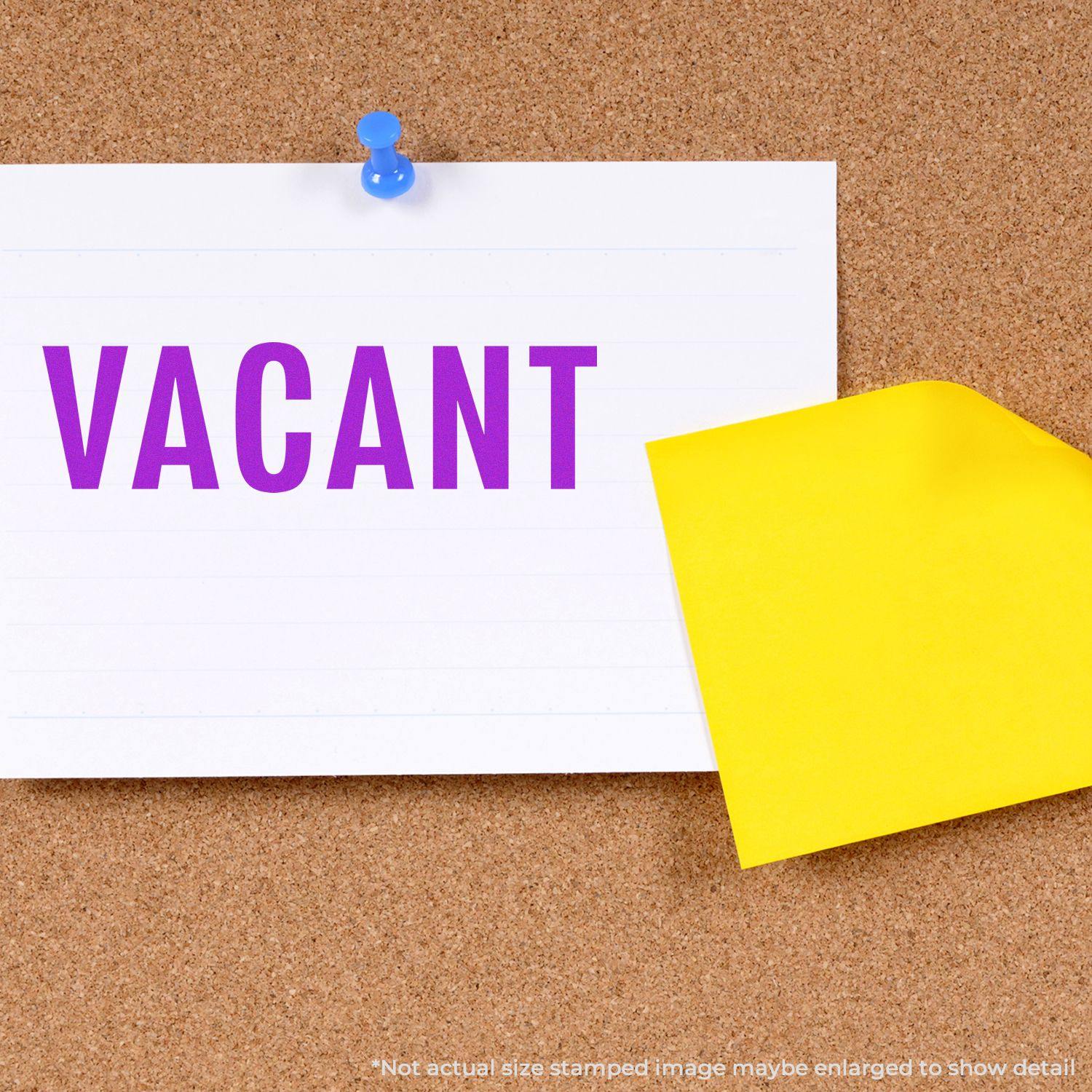 Self Inking Vacant Stamp used on a white card pinned to a corkboard, with a yellow sticky note partially covering the card.