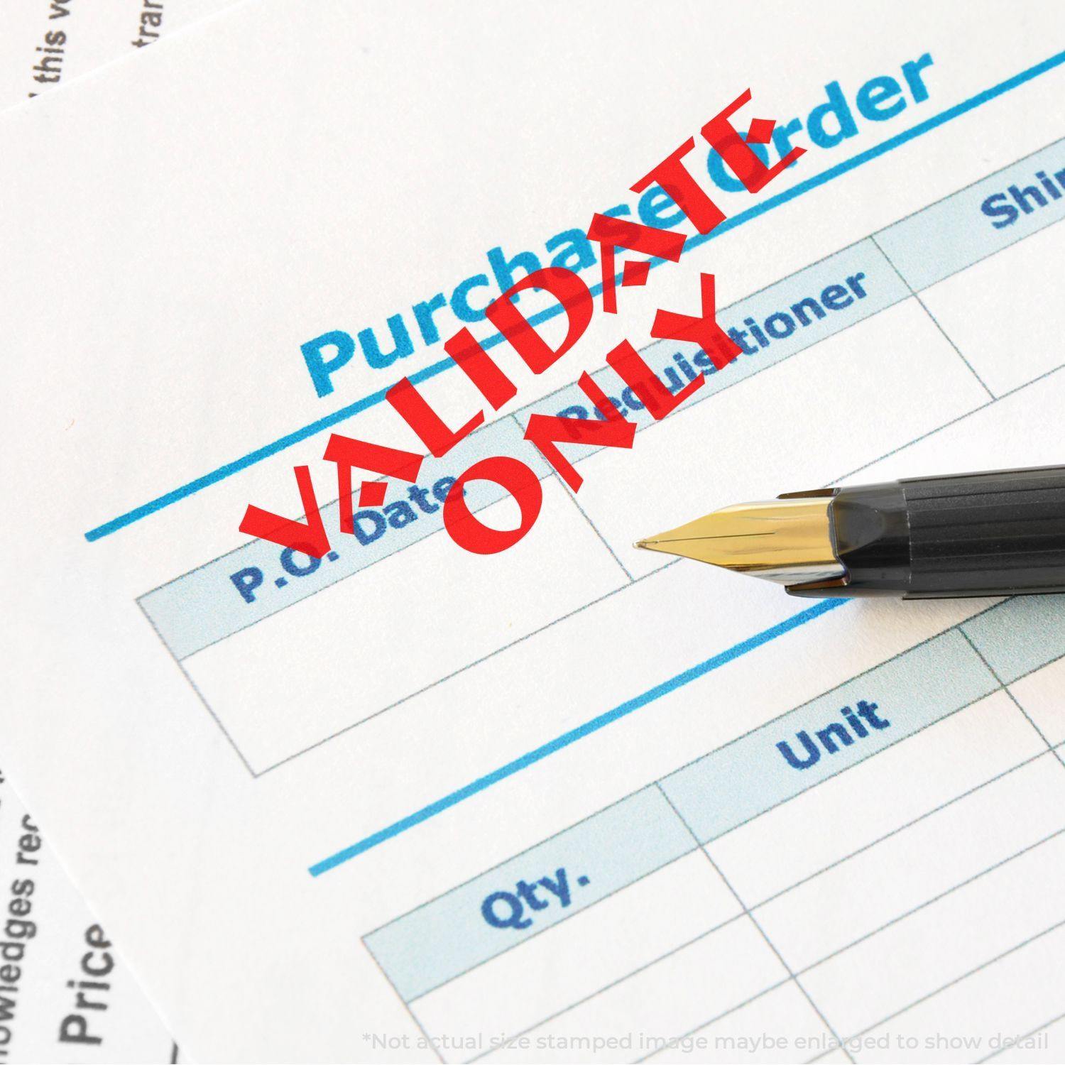 Slim Pre-Inked Validate Only Stamp in red ink on a purchase order form, with a pen resting beside the stamped text.