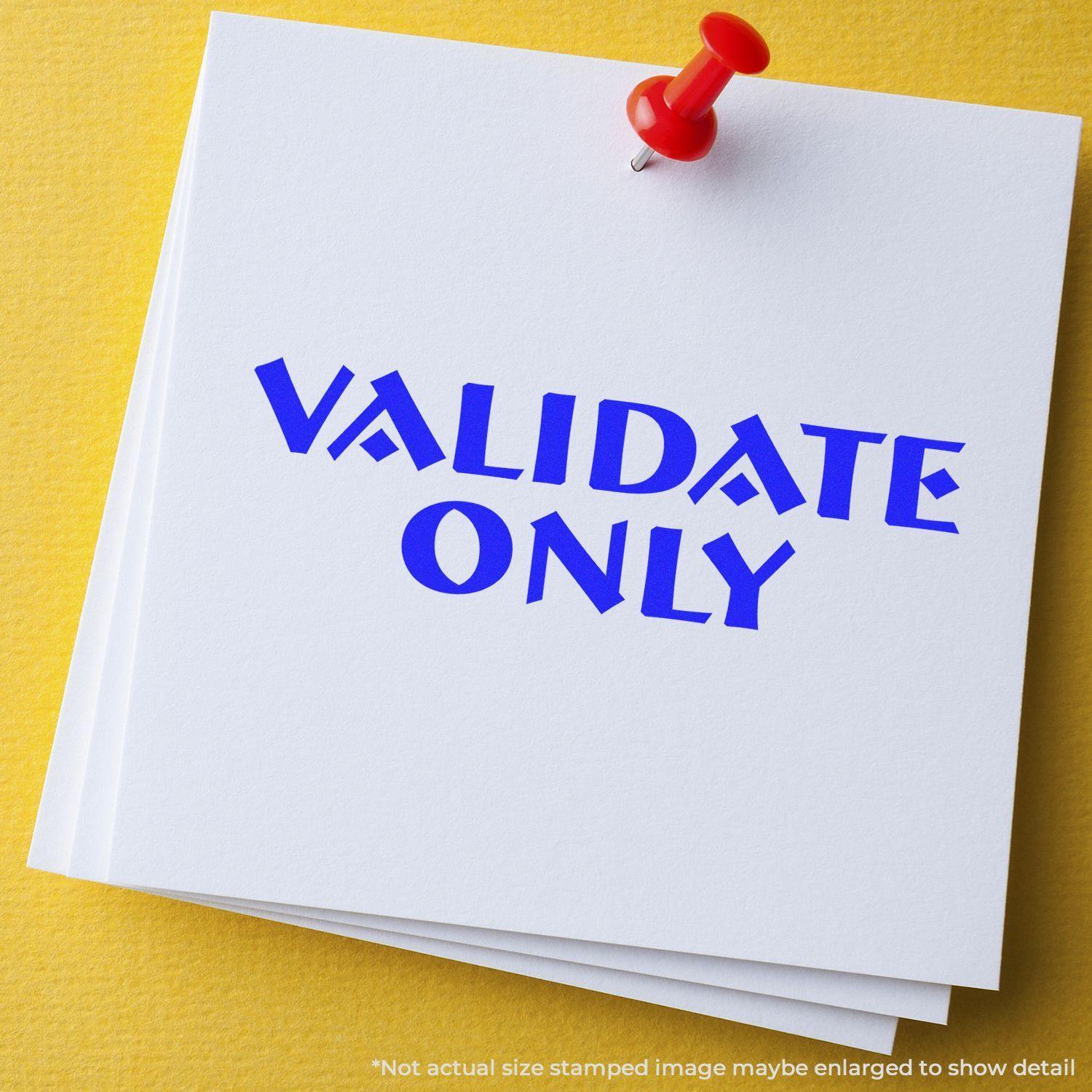 Large Pre-Inked Validate Only Stamp in blue ink on white paper, pinned with a red pushpin on a yellow background.