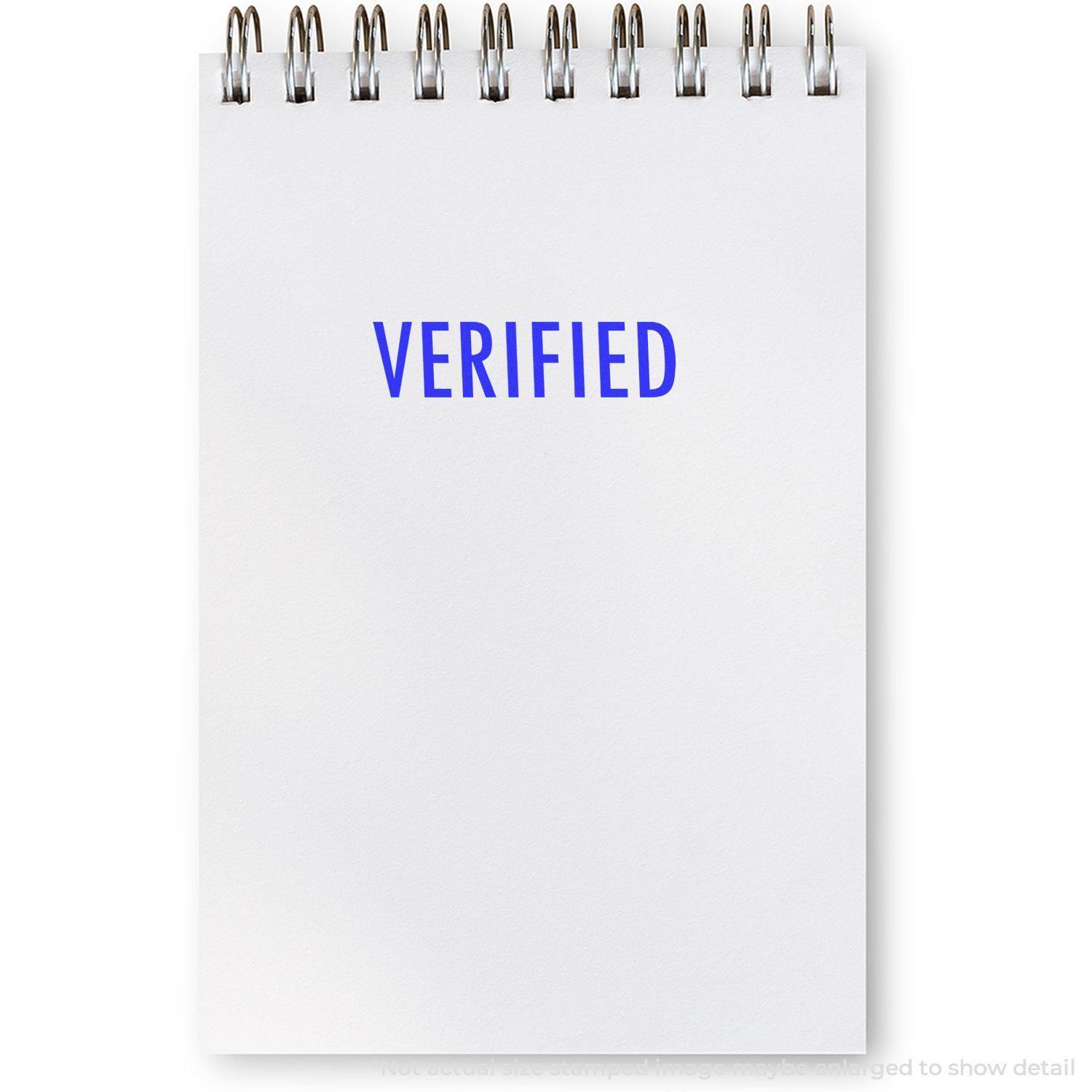 A notepad with the word "VERIFIED" stamped in blue ink using a Verified Rubber Stamp. The notepad has a spiral binding at the top.