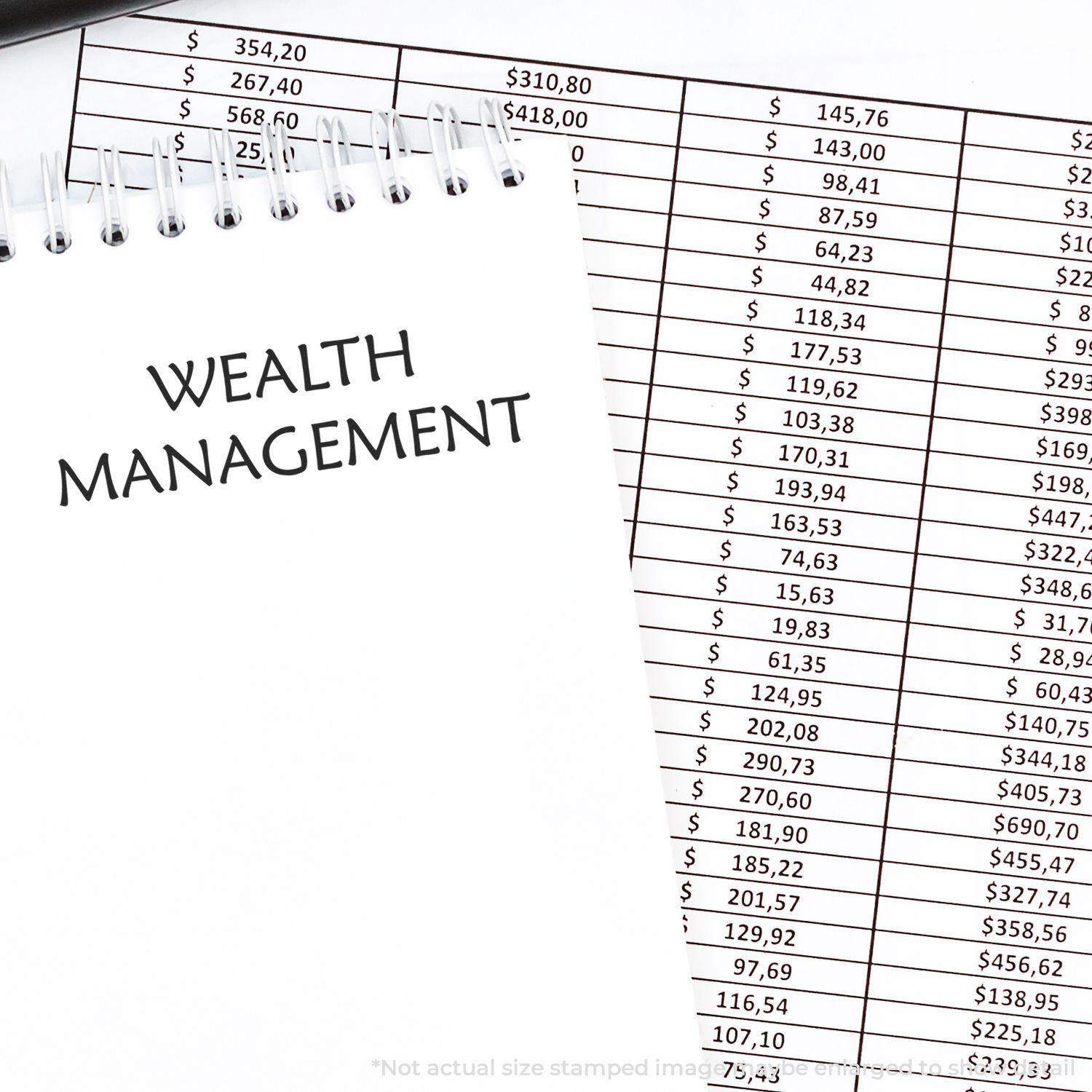 Wealth Management rubber stamp on a notepad next to a financial spreadsheet with various dollar amounts.