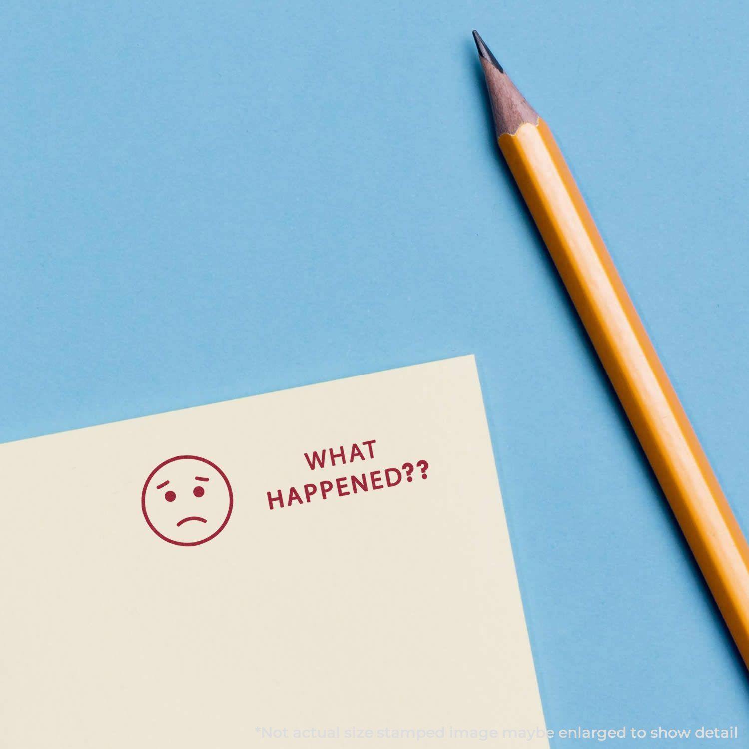 A yellow pencil next to a paper stamped with a sad face and the text What Happened?? in red ink on a blue background.