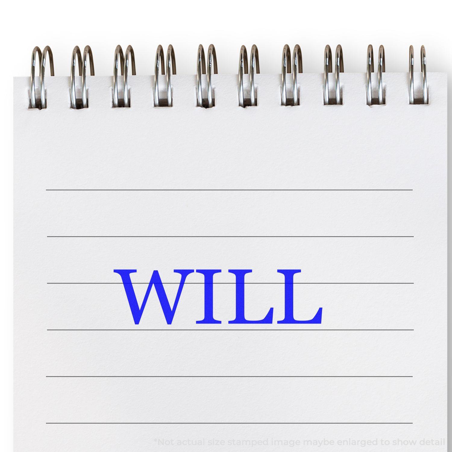 A Large Self Inking Will Stamp imprinting the word WILL in blue ink on a white notepad with spiral binding.