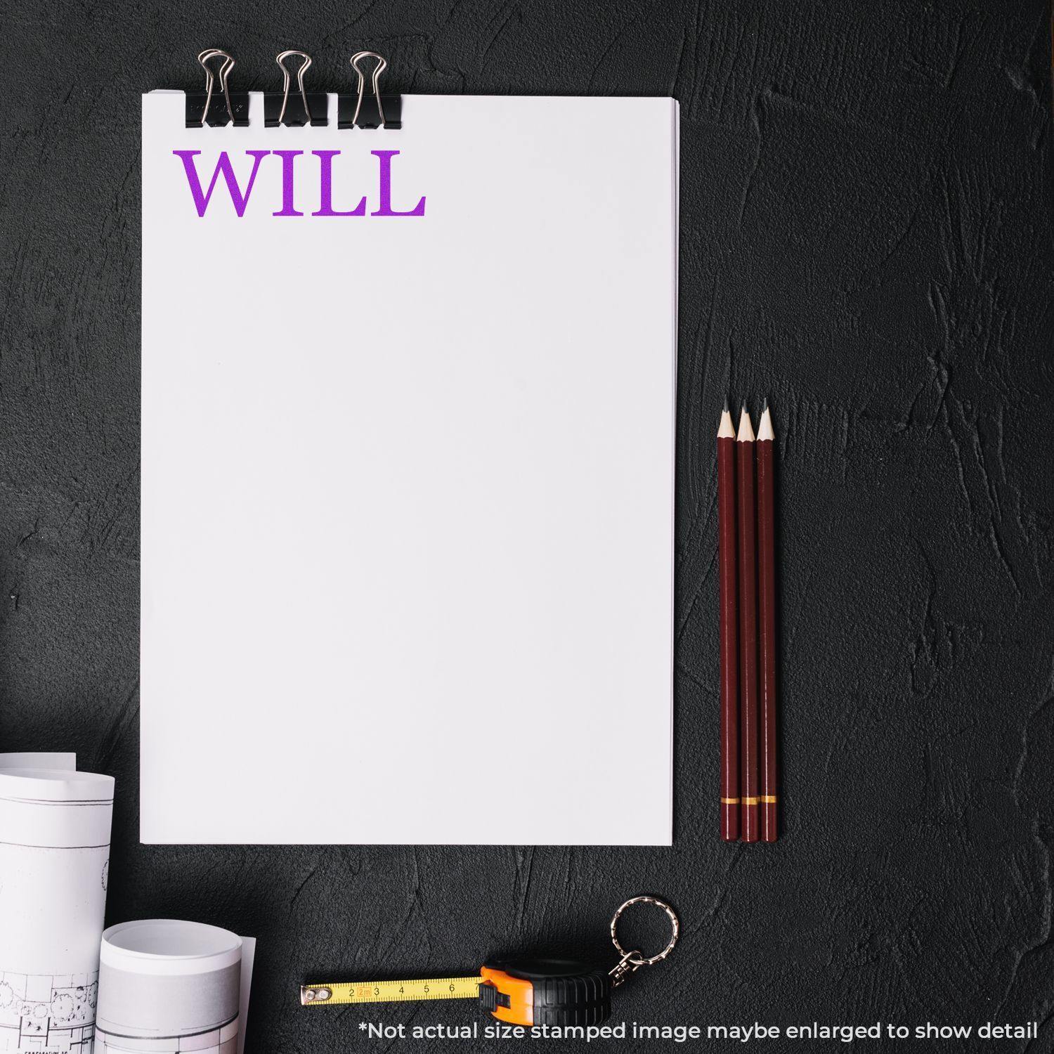 A blank paper with the word WILL in purple, surrounded by drafting tools, and a Will Legal Rubber Stamp impression on the paper.