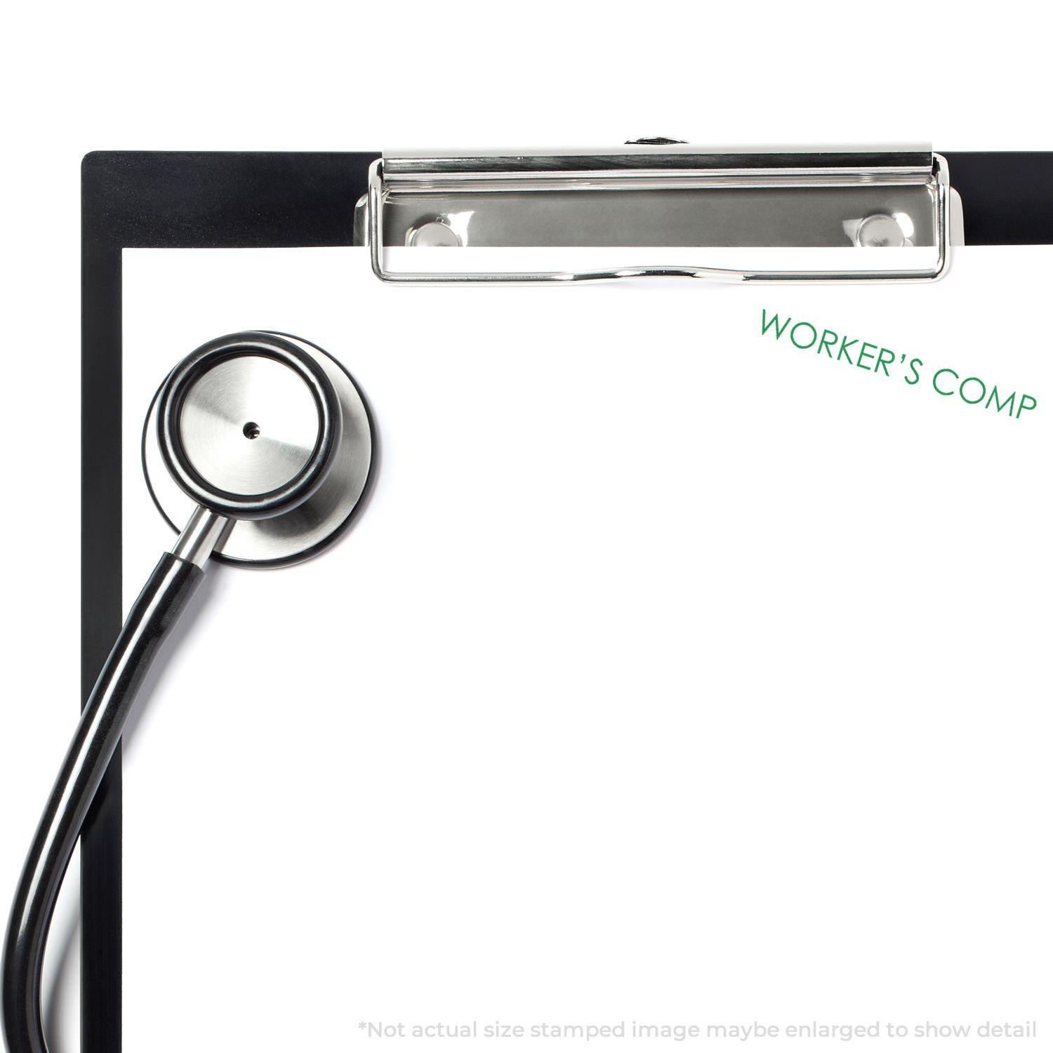 Large Self Inking Worker's Comp Stamp used on a clipboard with a stethoscope, showing the text WORKER'S COMP in green.