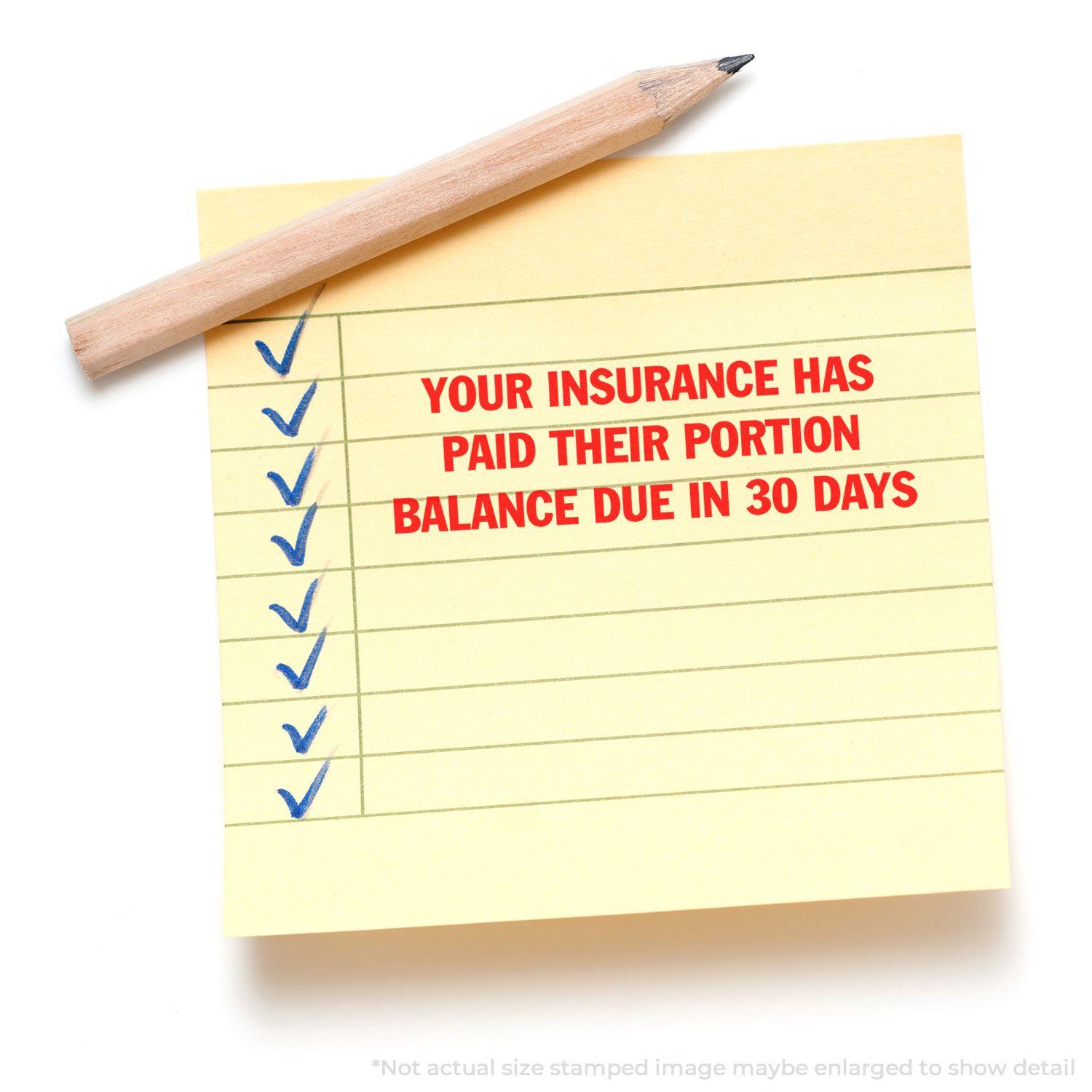 Slim Pre-Inked Your Insurance has Paid their Portion stamp on a yellow sticky note with a pencil and checkmarks.