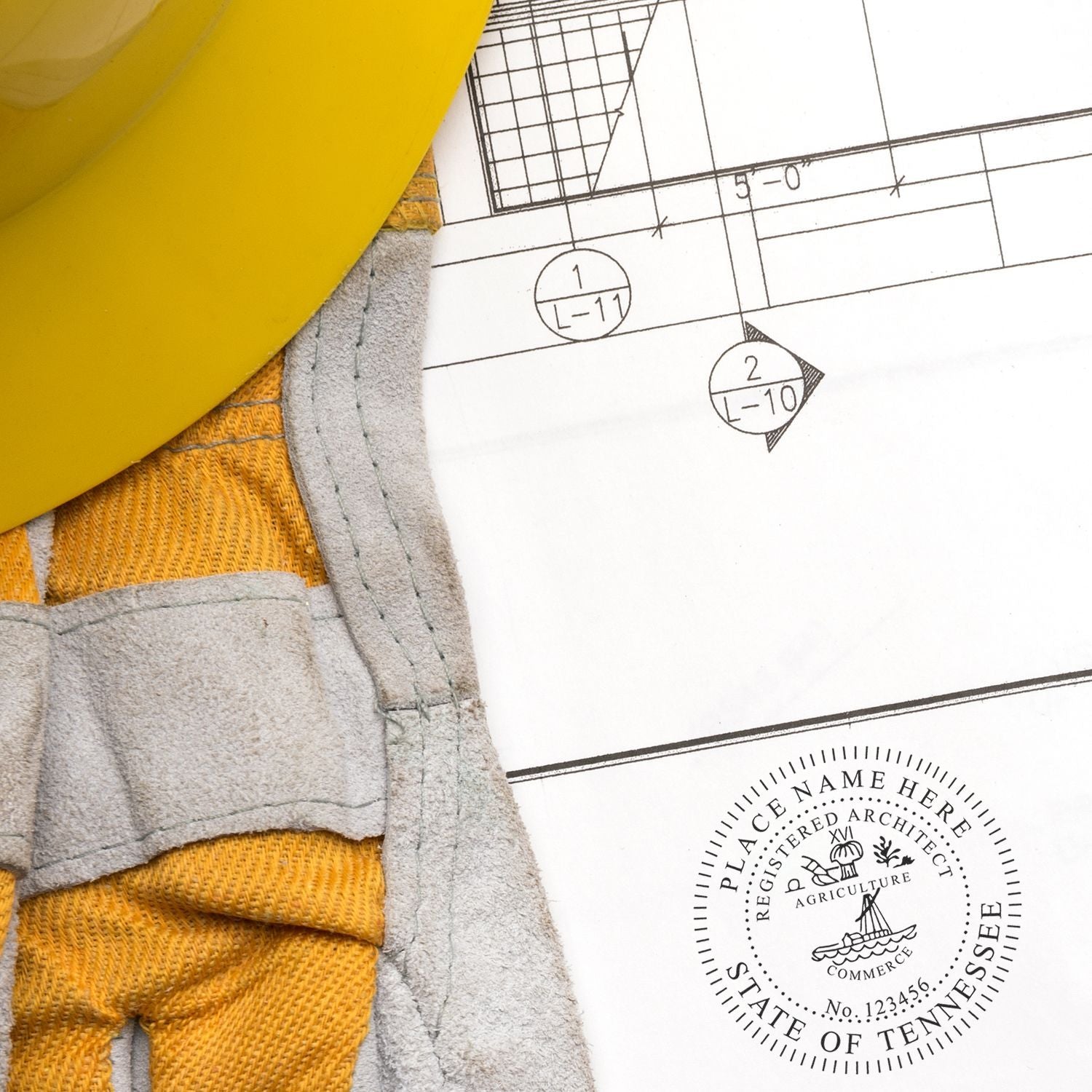 Self Inking Tennessee Architect Stamp on architectural blueprint with yellow hard hat and gloves nearby.