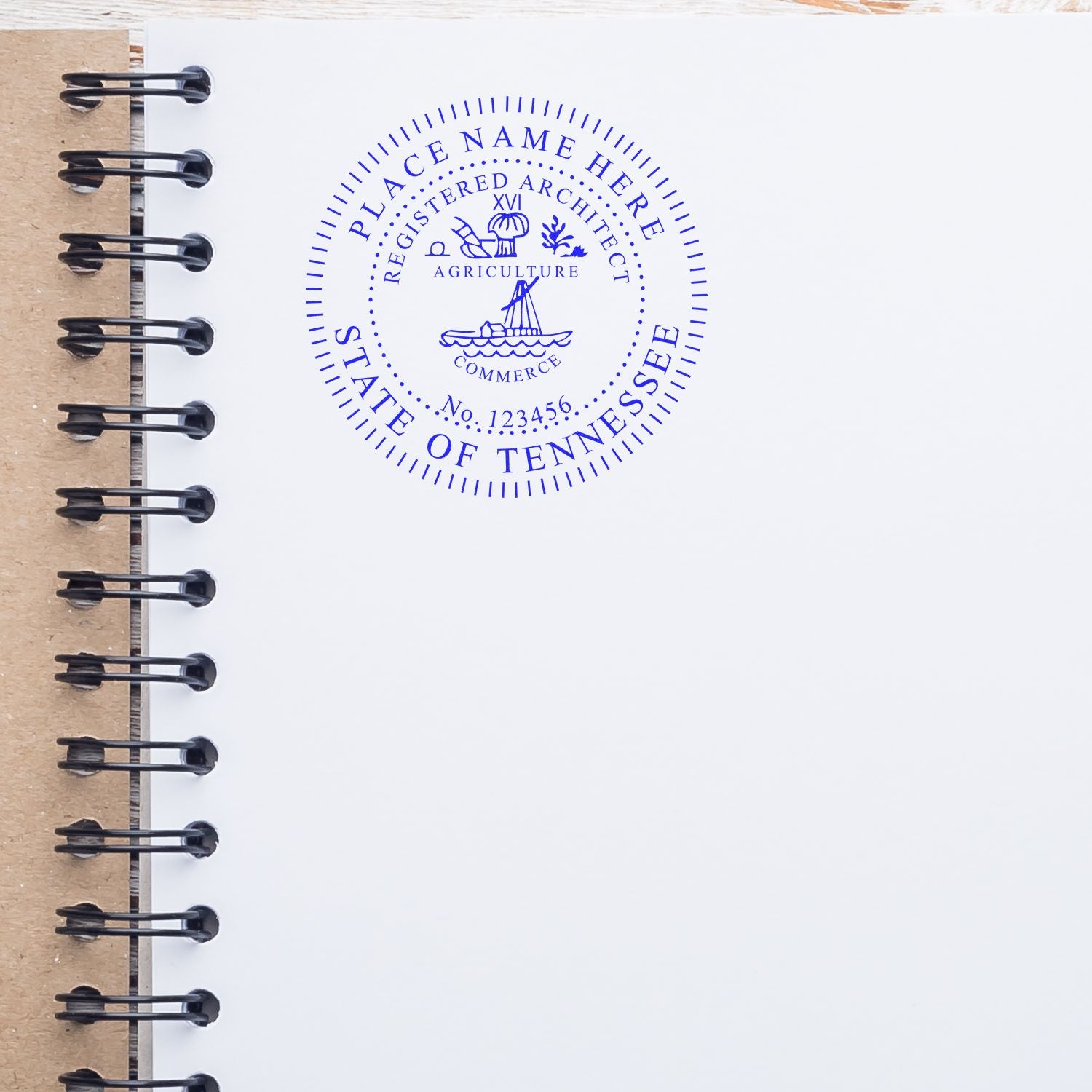 Tennessee Architect Seal Stamp in blue ink on a white page of a spiral-bound notebook, showcasing the detailed design and text.