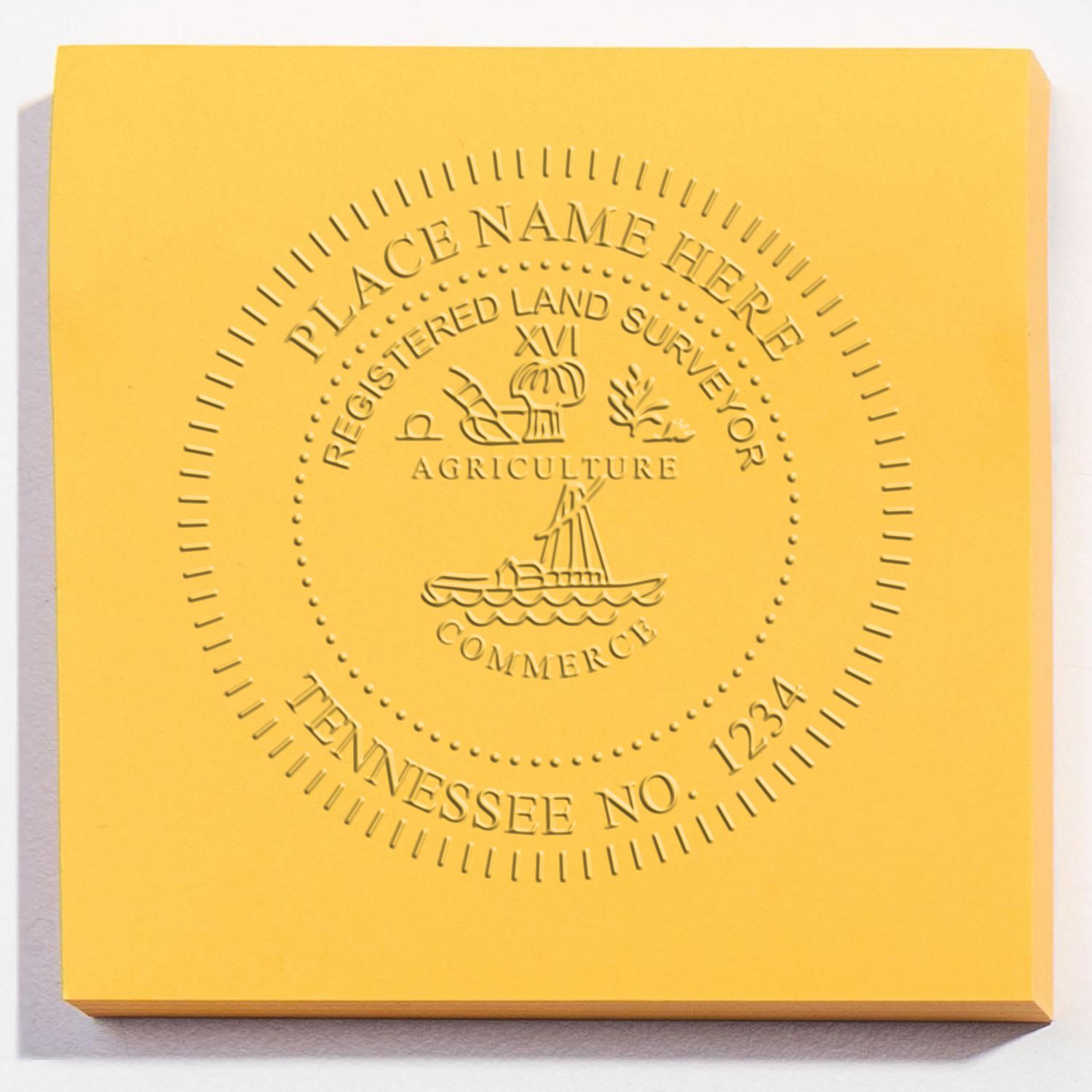 A lifestyle photo showing a stamped image of the Handheld Tennessee Land Surveyor Seal on a piece of paper