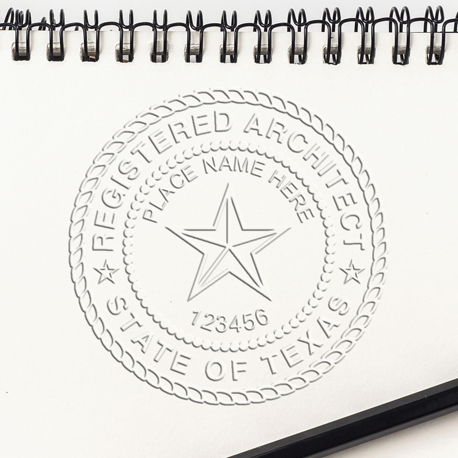 A lifestyle photo showing a stamped image of the Texas Desk Architect Embossing Seal on a piece of paper