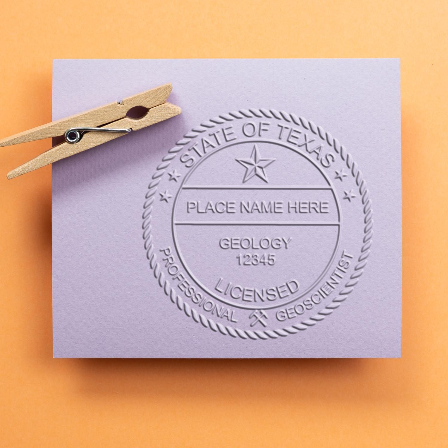 An in use photo of the Texas Geologist Desk Seal showing a sample imprint on a cardstock