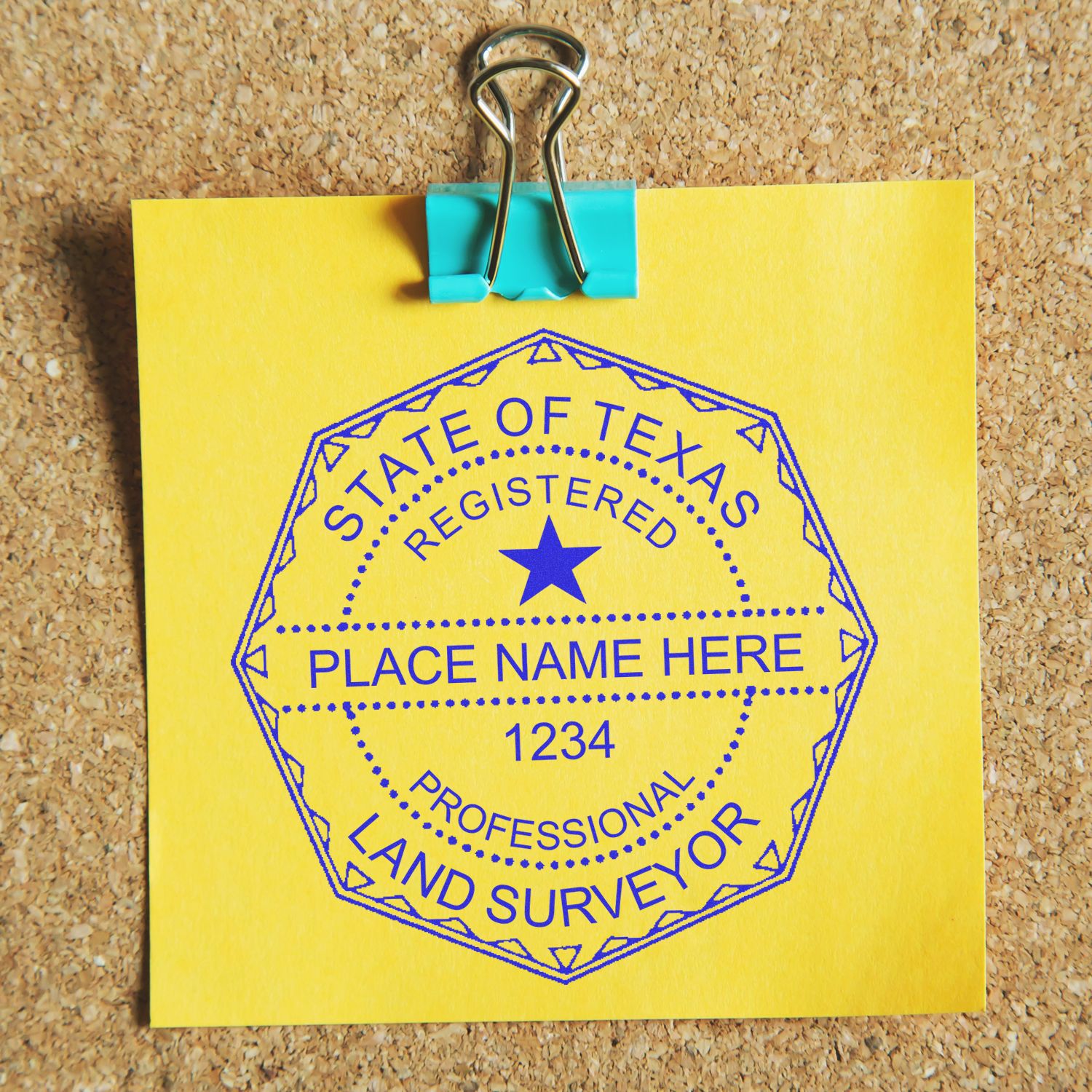 Self Inking Texas Land Surveyor Stamp on a yellow sticky note clipped to a corkboard, displaying a professional seal with customizable details.