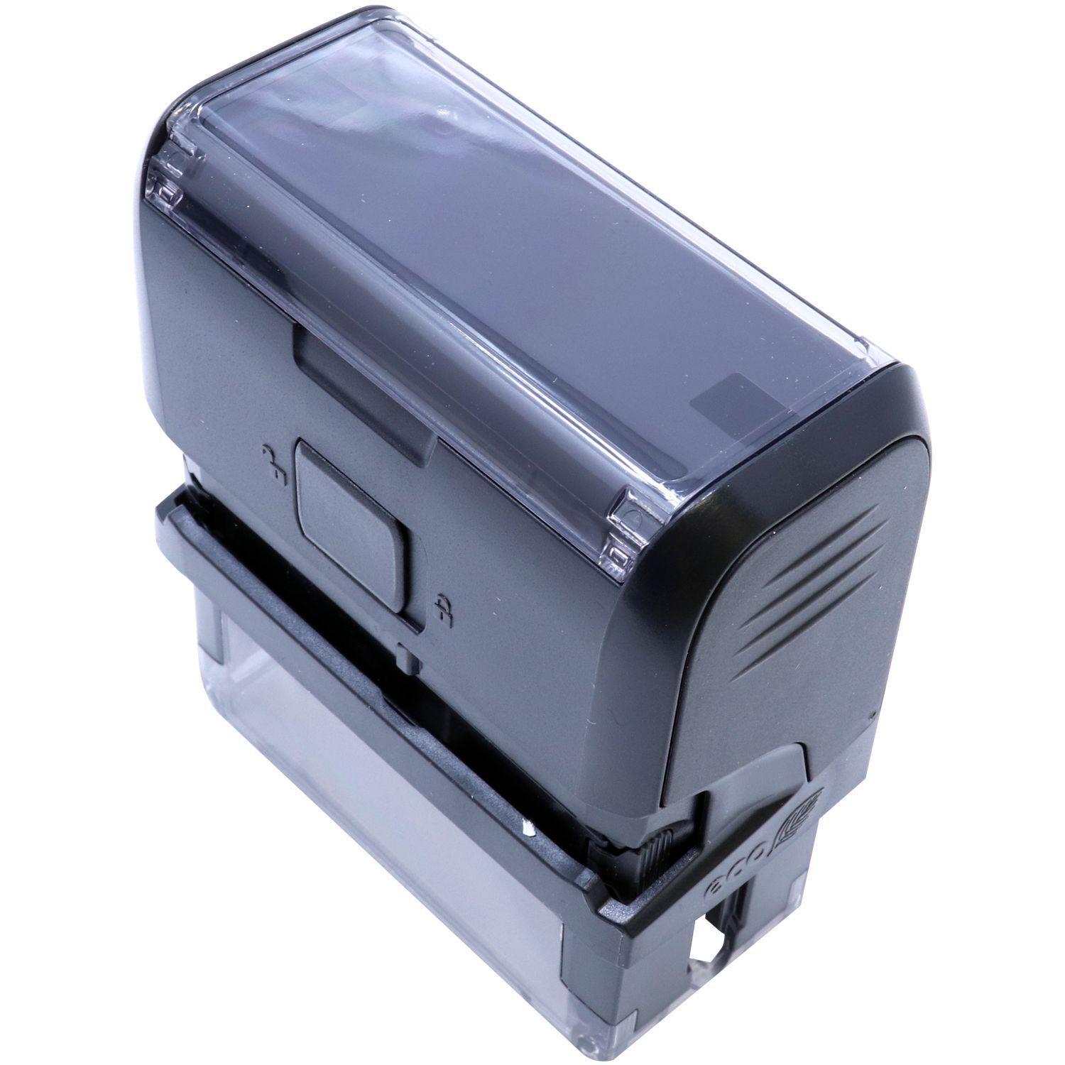 Black Self Inking Progress Stamp with a transparent base and a rectangular design, shown from an angled side-back view.