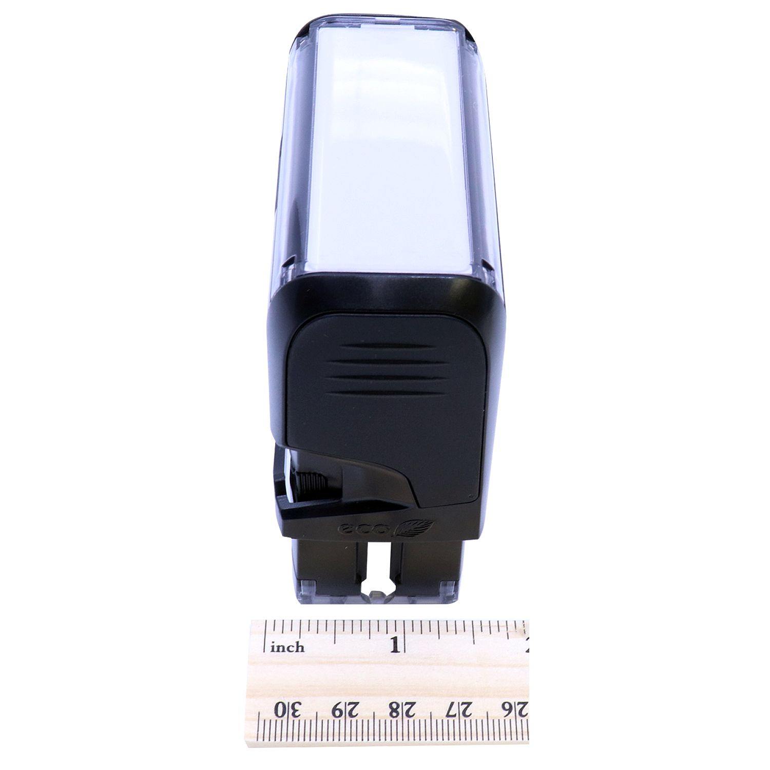 Self Inking Superceded Stamp in black, shown from an angled side view, with a ruler in front for scale.