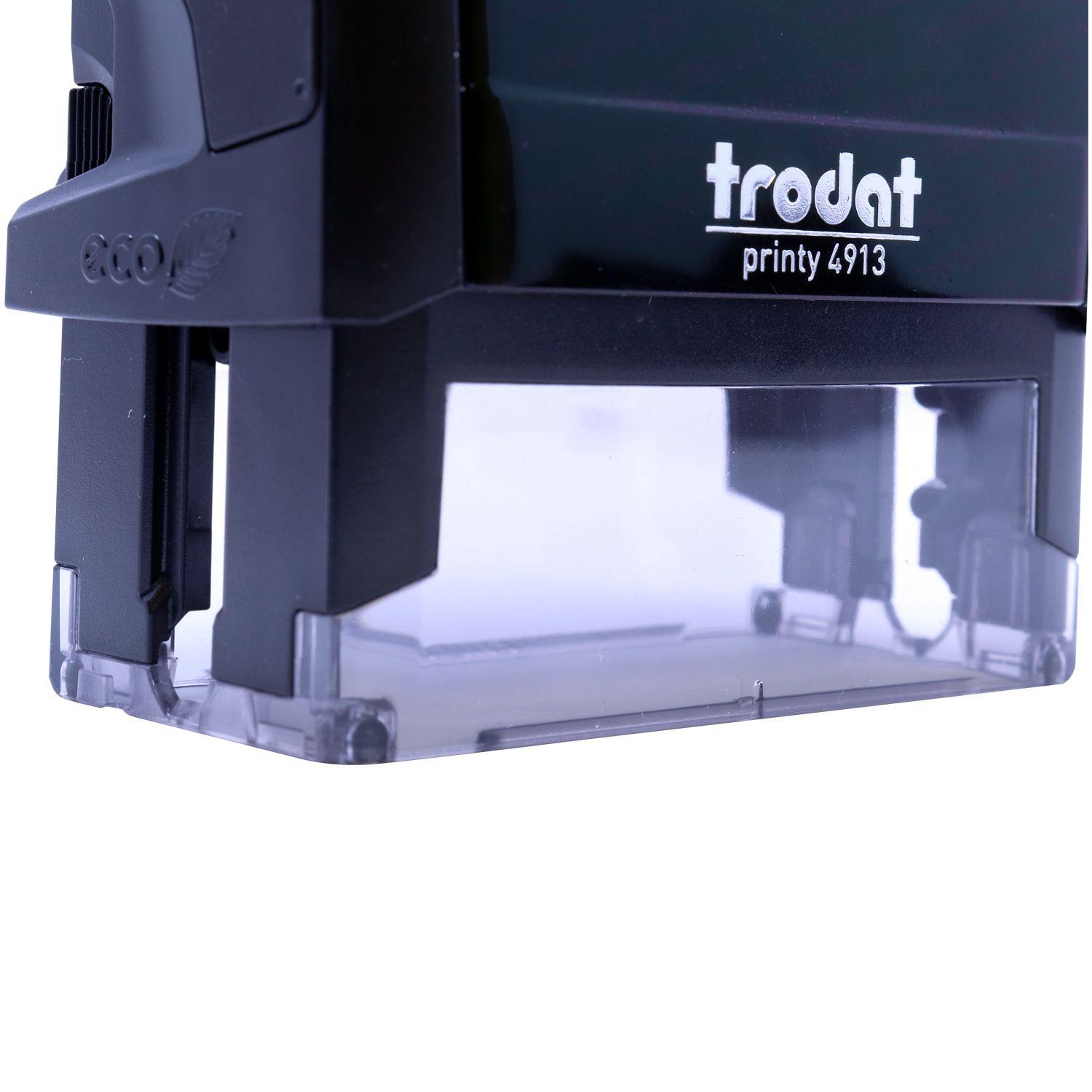 Close-up of a black Trodat Printy 4913 Self Inking Progress Stamp with a clear base, showing the eco-friendly logo on the side.