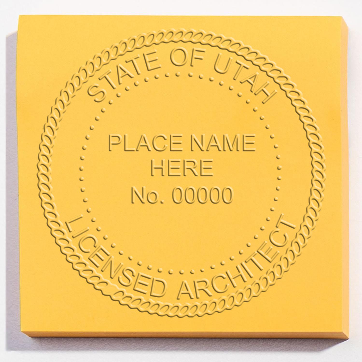 A lifestyle photo showing a stamped image of the Utah Desk Architect Embossing Seal on a piece of paper