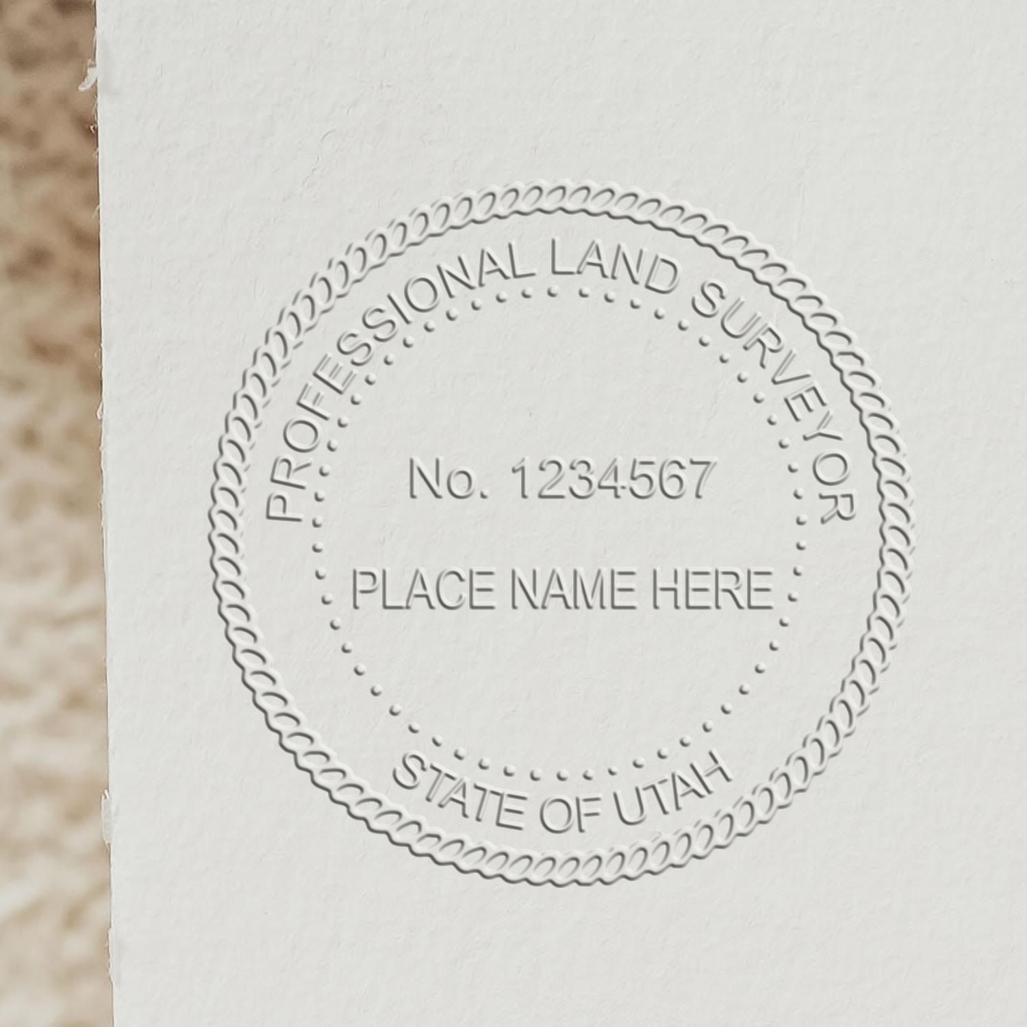 A lifestyle photo showing a stamped image of the Utah Desk Surveyor Seal Embosser on a piece of paper