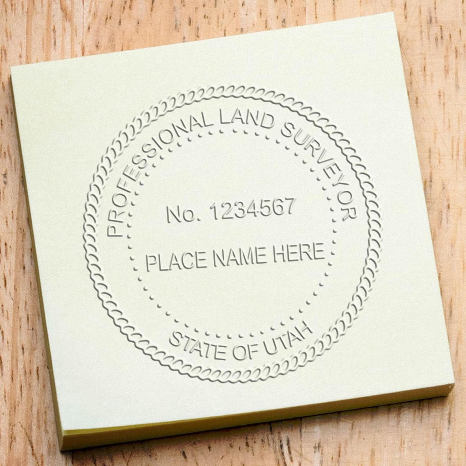 A stamped impression of the Handheld Utah Land Surveyor Seal in this stylish lifestyle photo, setting the tone for a unique and personalized product.