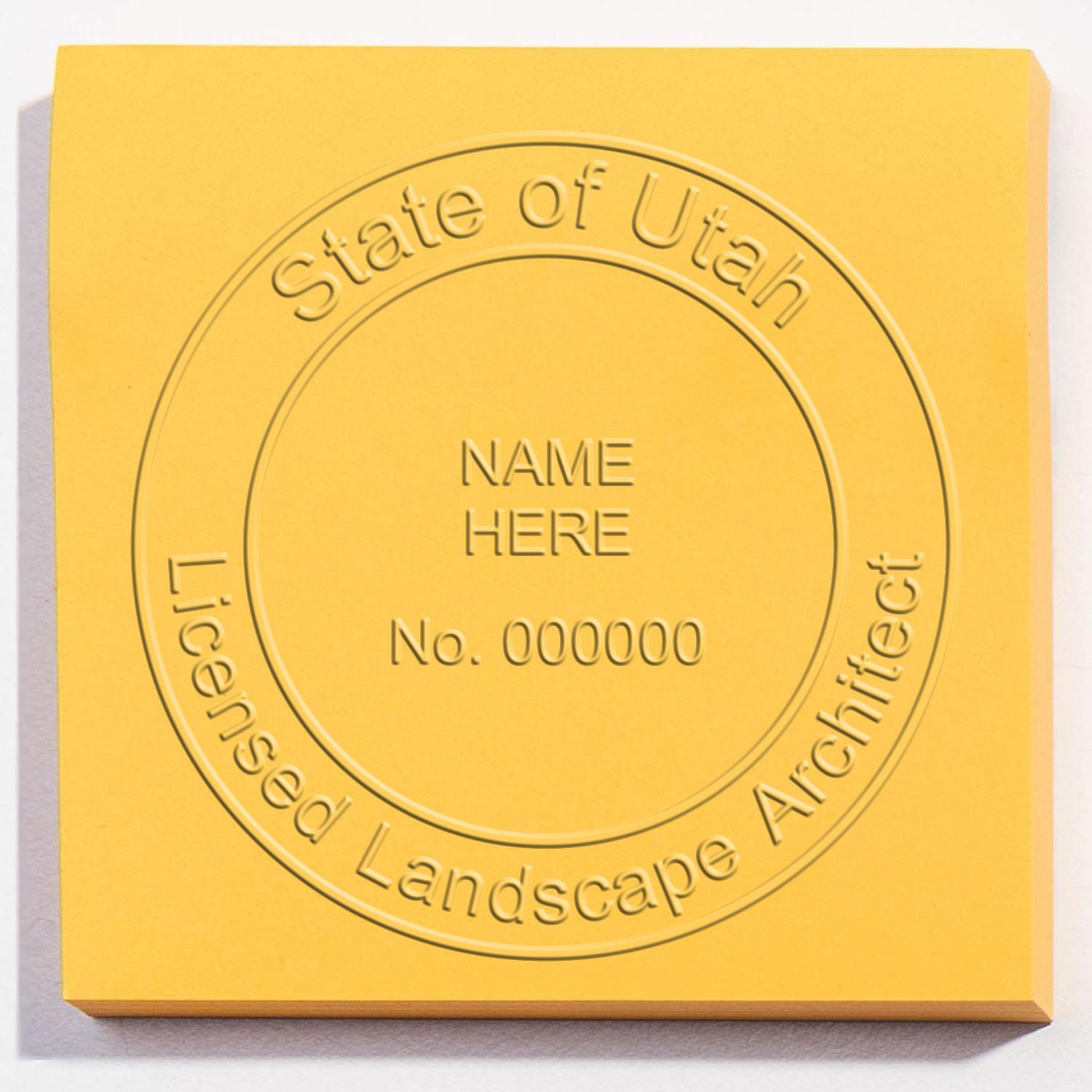 An alternative view of the Heavy Duty Utah Landscape Architect Cast Iron Embosser stamped on a sheet of paper showing the image in use