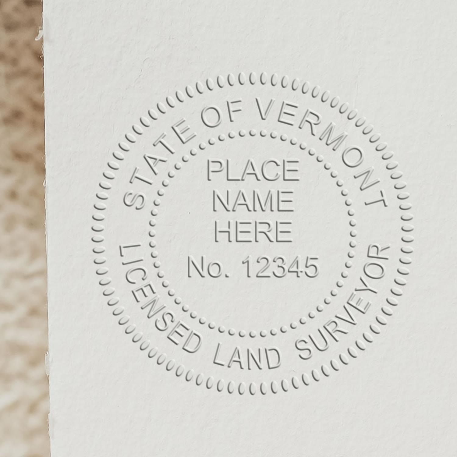 A stamped impression of the Vermont Desk Surveyor Seal Embosser in this stylish lifestyle photo, setting the tone for a unique and personalized product.